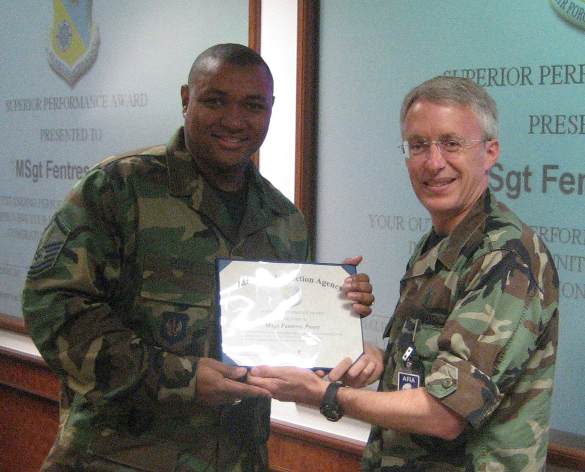 SPANGDAHLEM AIR BASE, GERMANY -- Master Sgt. Fentress Posey, 52nd Medical Group, accepts a certificate for superior performance from Col. Ronald Nelson, Air Force Inspector General’s Office, Health Services Inspection Team Chief, upon completion of the Air Force Inspection Agency’s Health Services Inspection and the civilian Accreditation Association for Ambulatory Health Care. (US Air Force photo/Capt. Ross Birdsong)