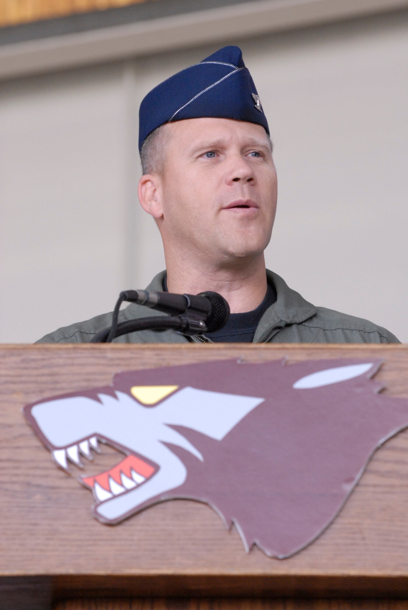 Colonel Jeff Lofgren, former 8th Fighter Wing commander, speaks to the wing and fellow Wolf Pack members one last time during the change of command ceremony here May 25. The colonel thanked Airmen for what they did everyday but also for being his family and sharing time with them. He continues his career at Headquarters Air Force at the Pentagon. (U.S. Air Force photo by Senior Airman Barry Loo)