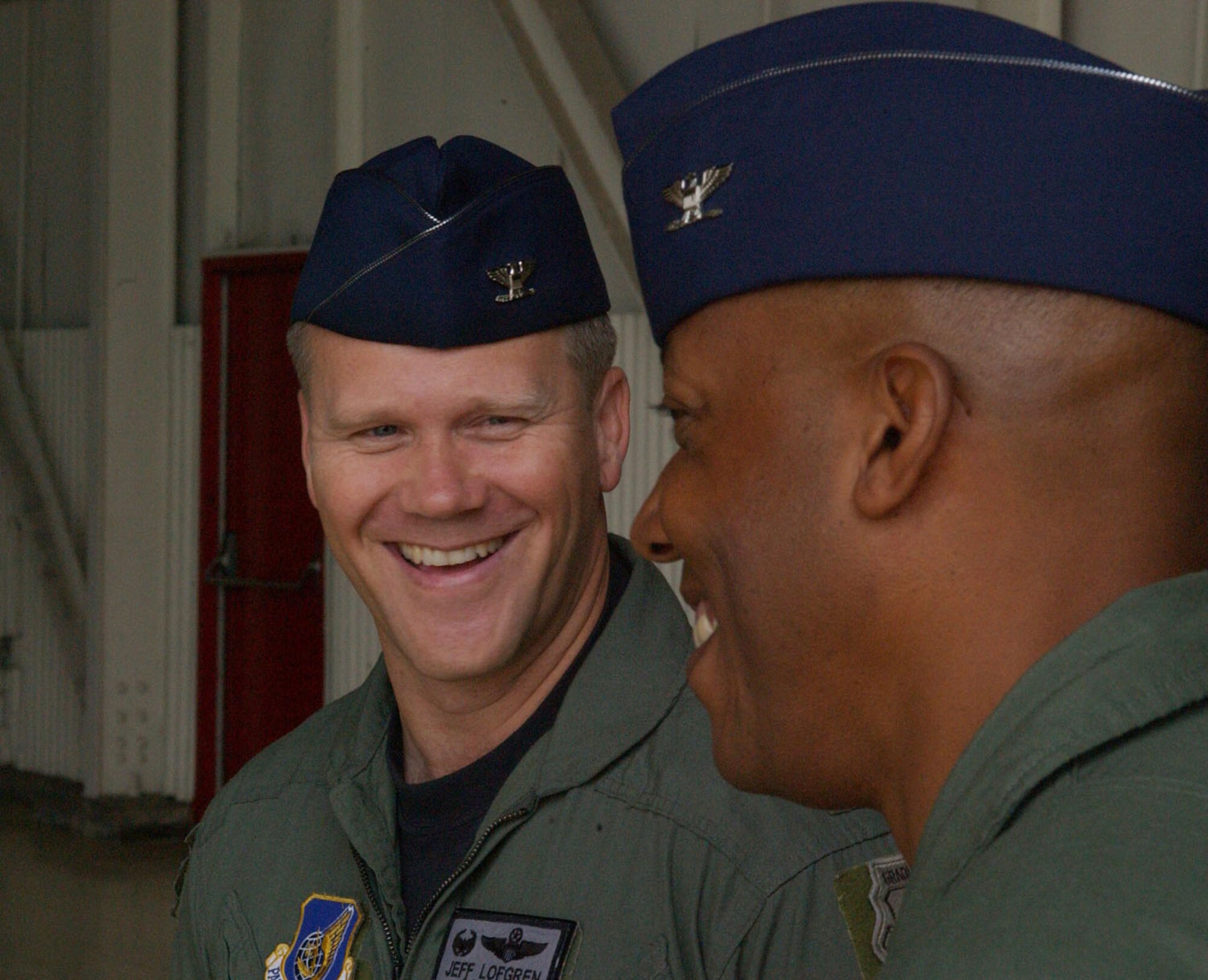 Colonel Charles "Wolf" Brown, the new 8th Fighter Wing commander, speaks to Colonel Jeffery Lofgren, outgoing Wing commander, before the change of command ceremony here May 25. During his speech, Brown said he will lead the Wolf Pack "using four tenets that have defined how I have operated during my career -- execute at a high standard, be disciplined in execution, pay attention to the details, and have fun." He was last assigned as commandant, U.S. Air Force Weapons School, 57th Wing, Nellis Air Force Base, Nev.  (U.S. Air Force photo/Senior Airman Steven Doty)                               