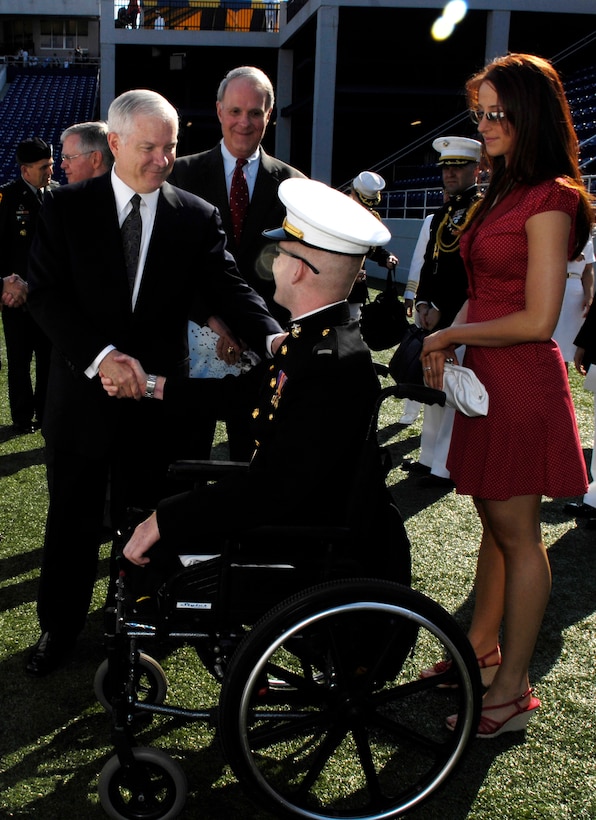 Secretary of Defense Robert M. Gates shakes hands with U.S. Marine 1st Lt. Andrew Kinard who was wounded in Iraq, during the U.S. Naval Academy graduation and commissioning ceremony in Annapolis, Md., May 25, 2007.
