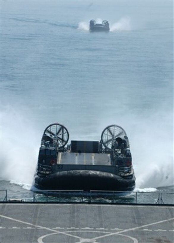 Two landing craft air cushions, also known as LCACs, prepare to enter the well deck of the amphibious dock landing ship USS Tortuga (LSD 46) while at sea on May 20, 2007.  