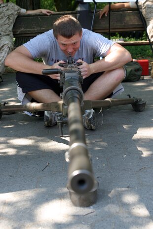 Shawn T. Cole, an 11th grader in high school, looks through the sights of a .50-caliber Browning machine gun during a static display Marine Corps weapons in Central Park, N.Y., May 25. Cole said he plans on joining the Marine Corps in a few years.