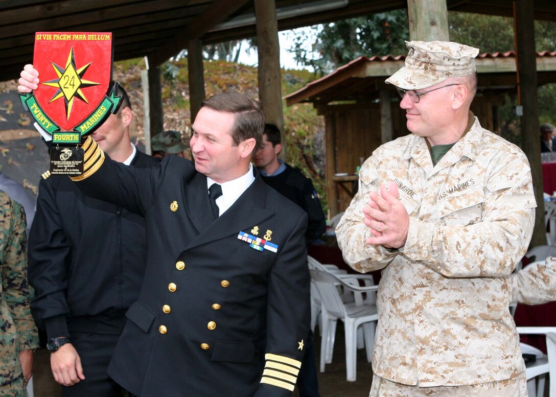 SALINAS, Chile - Chilean Capt. Tulio Rojas, Commander of Detachment Miller, holds up a gift from Col. Brent Dunahoe, commanding officer of 24th Marine Regiment, at the conclusion of a barbeque and soccer game here. The plaque from Special Purpose Marine Air Ground Task Force 24 commemorates the services' support of Partnership of the Americas 2007, an exercise to increase regional security and cooperation in the Western Hemisphere.