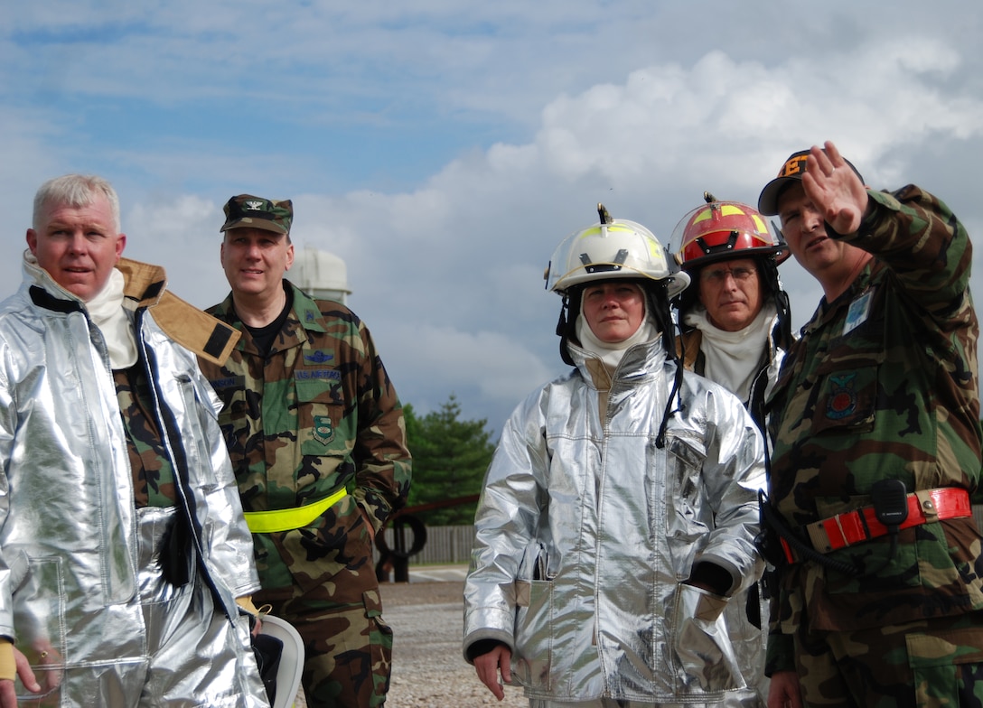 Command Chief Master Sgt. Merle Lyman, Col. Jeff Johnson, Col. Maryanne Miller, Col. James Patterson, and Chief Master Sgt. Ralph Browning discuss plans as the 932nd Airlift Wing firefighting Reservists showed their commander how to put out fires Illinois!  Photo/Capt. Stan Paregien