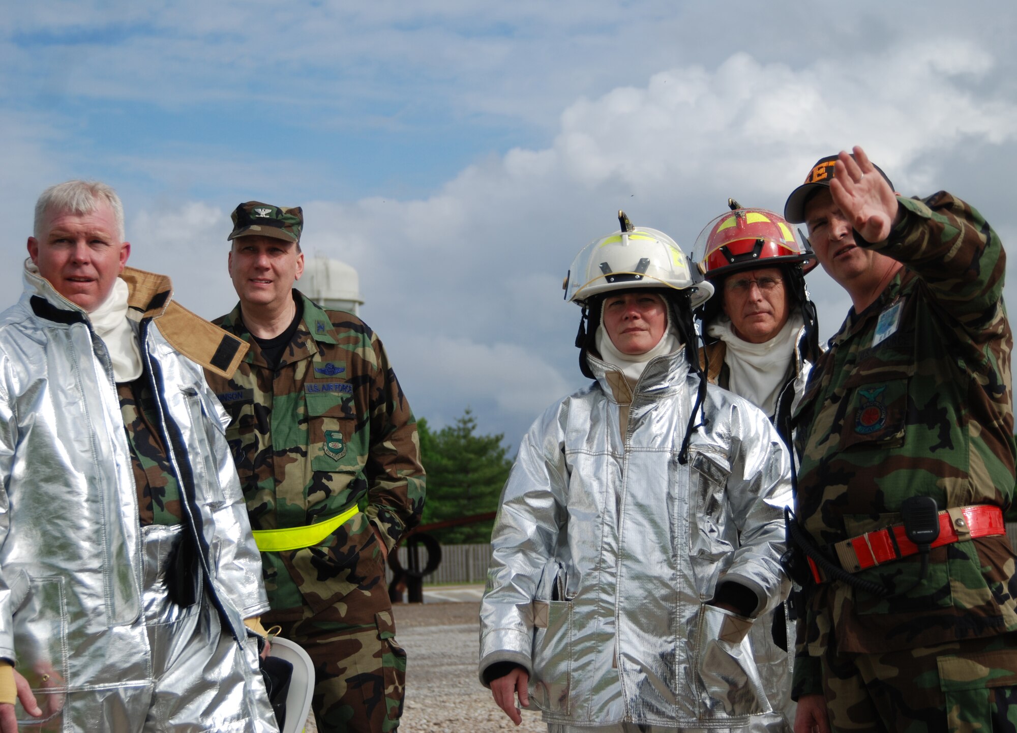 Command Chief Master Sgt. Merle Lyman, Col. Jeff Johnson, Col. Maryanne Miller, Col. James Patterson, and Chief Master Sgt. Ralph Browning discuss plans as the 932nd Airlift Wing firefighting Reservists showed their commander how to put out fires Illinois!  Photo/Capt. Stan Paregien