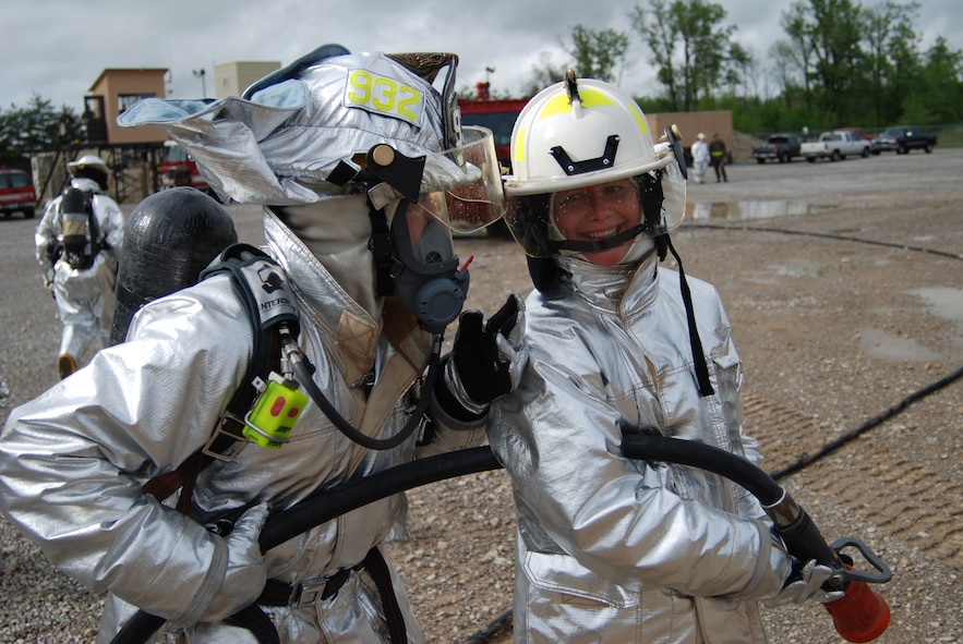 Commander of the 932nd Airlift Wing, Col. Maryanne Miller works on putting out a fire at Scott Air Force Base training.  932nd firefighting was at its best in Illinois.  Photo/Capt. Stan Paregien