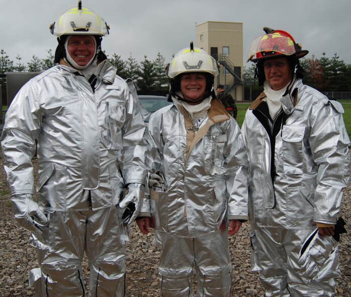 932nd Airlift Wing Command Chief Master Sgt. Merle Lyman, former commander Col. Maryanne Miller, and new 932nd Medical Group commander Col. James Patterson, are all smiles after their experience firefighting with the Air Force Reserve Command firefighters in Illinois. 932nd Airlift Wing firefighters spent time sharing the water hoses with some of the Air Force Reserve wing leadership at Scott Air Force Base. The Reserve wing trained during a four day exercise in 2007. Photo/Capt. Stan Paregien 