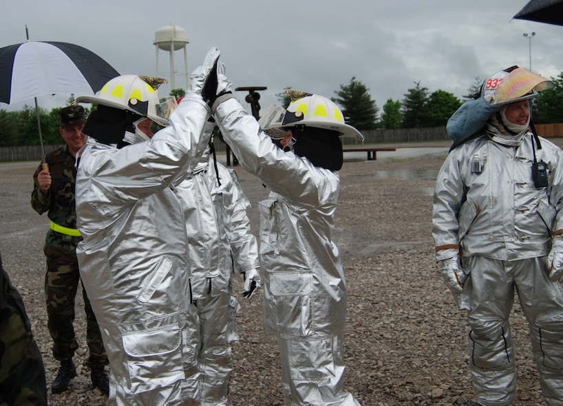 932nd Airlift Wing Command Chief Master Sgt. Merle Lyman gives a congratulatory high five to Col. Maryanne Miller after they put out several fires during training.  The 932nd firefighting Reservists showed their commander how to put out fires Illinois!  Photo/Capt. Stan Paregien
