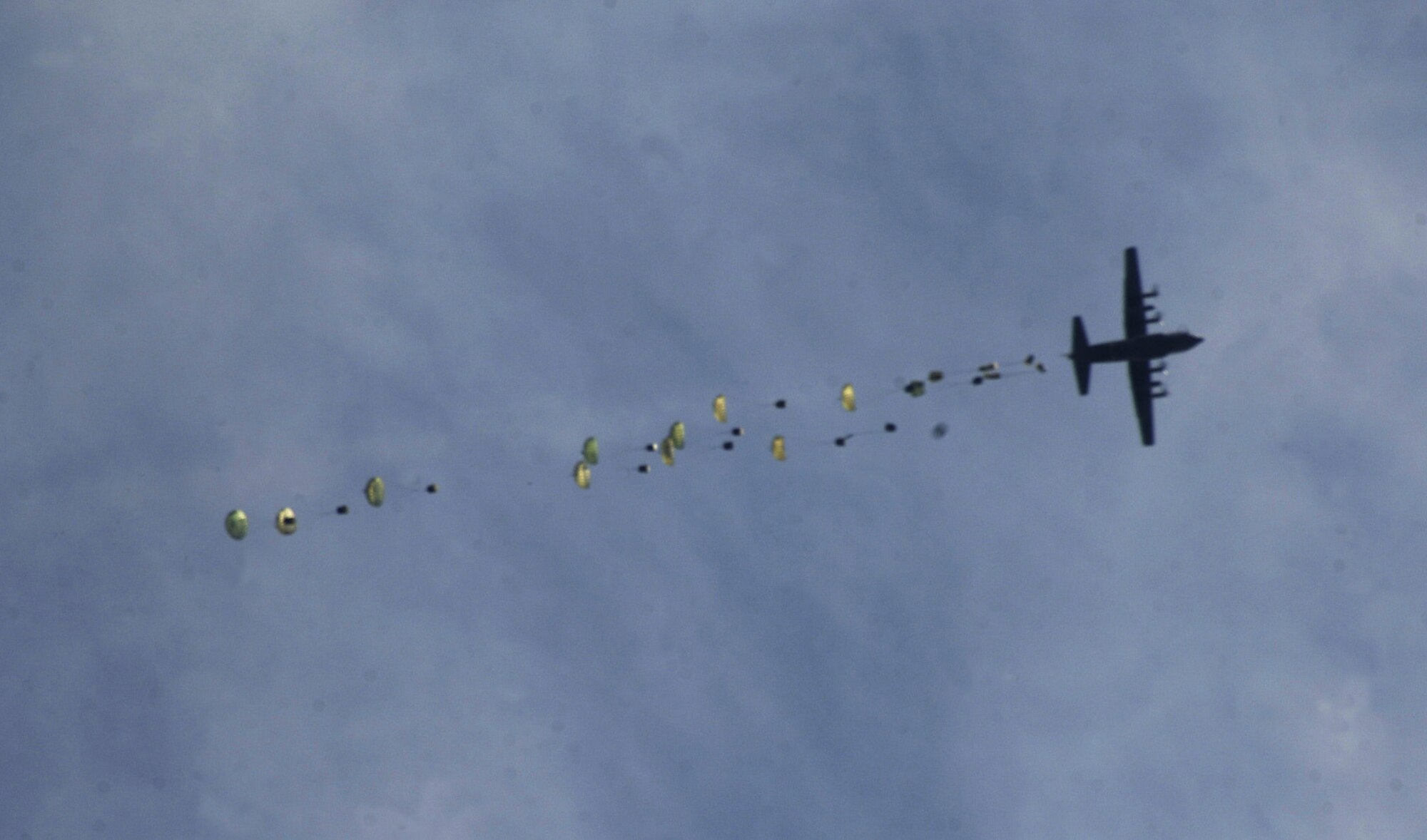A C-130 Hercules airdrops humanitarian assistance supplies in Paroons, Afghanistan, May 3. Coalition C-130s and C-17 Globemaster IIIs flew 147 sorties and delivered approximately 480 tons of cargo May 26. (U.S. Army photo/Staff Sgt. Michael L. Casteel)