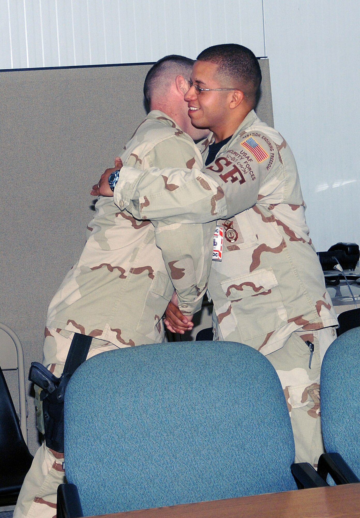 Senior Airman Carlos Moreno, 455th Expeditionary Security Forces Squadron, receives congratulations from fellow security forces Airmen after exchanging vows with his fiancee, Carolina, via a video teleconference from Bagram Airfield, Afgahnistan to Vandenberg Air Force Base, Calif. Airman Moreno is deployed from the 30th Security Forces Squadron at Vandenberg. (photo by Staff Sgt. Craig Seals)