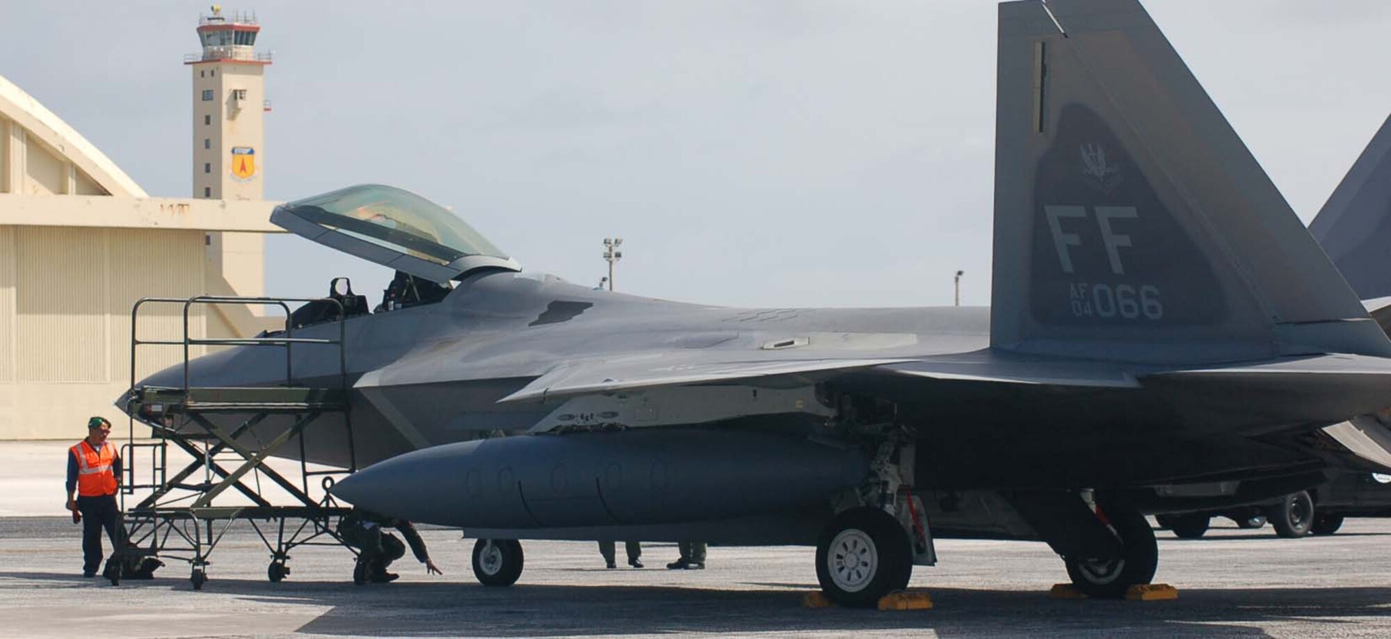 A Transient Alert maintenance technician examines an F-22A following its arrival May 10. (Photo by Maj. David Boles/36th Maintenance Squadron commander)