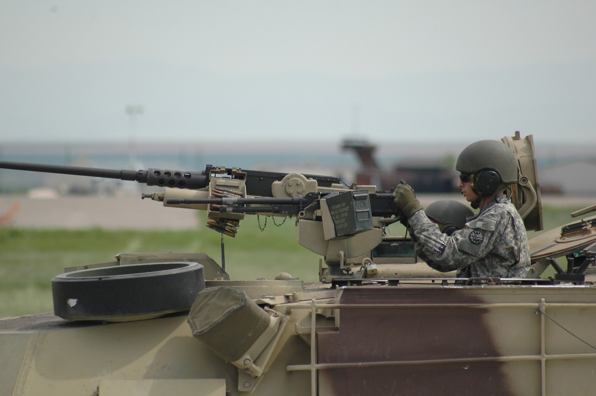 An Army National Guard member demonstrates the fire power aboard an M1A1 Abrams tank during the open house and air show at Malmstrom Air Force Base May 20. (U.S. Air Force photo by Airman 1st Class Emerald Ralston)