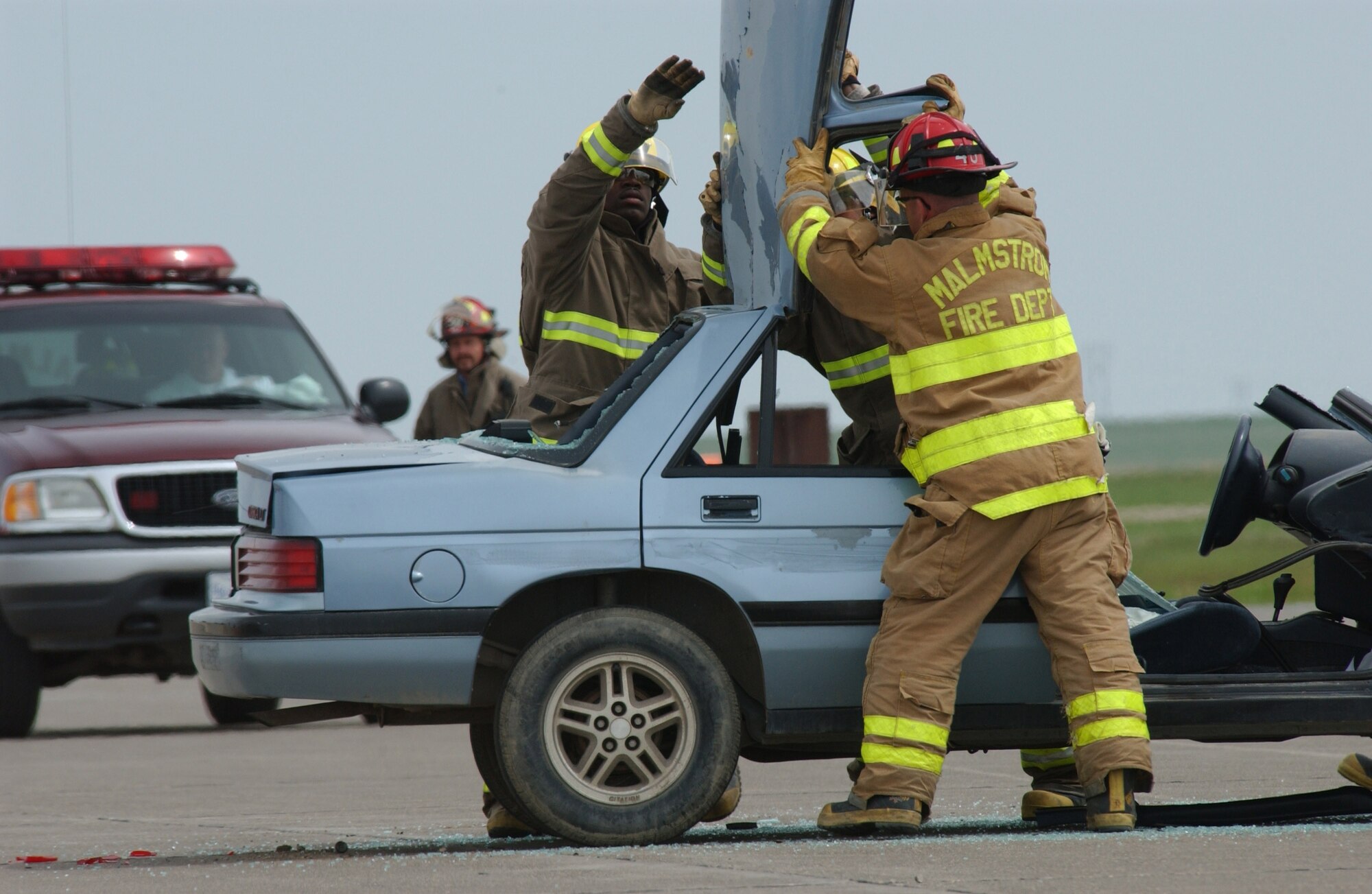 Members of Malmstrom's fire department demonstrate how the jaws of life work during a demonstration at the open house and air show May 20. (U.S. Air Force photo by John Turner)
