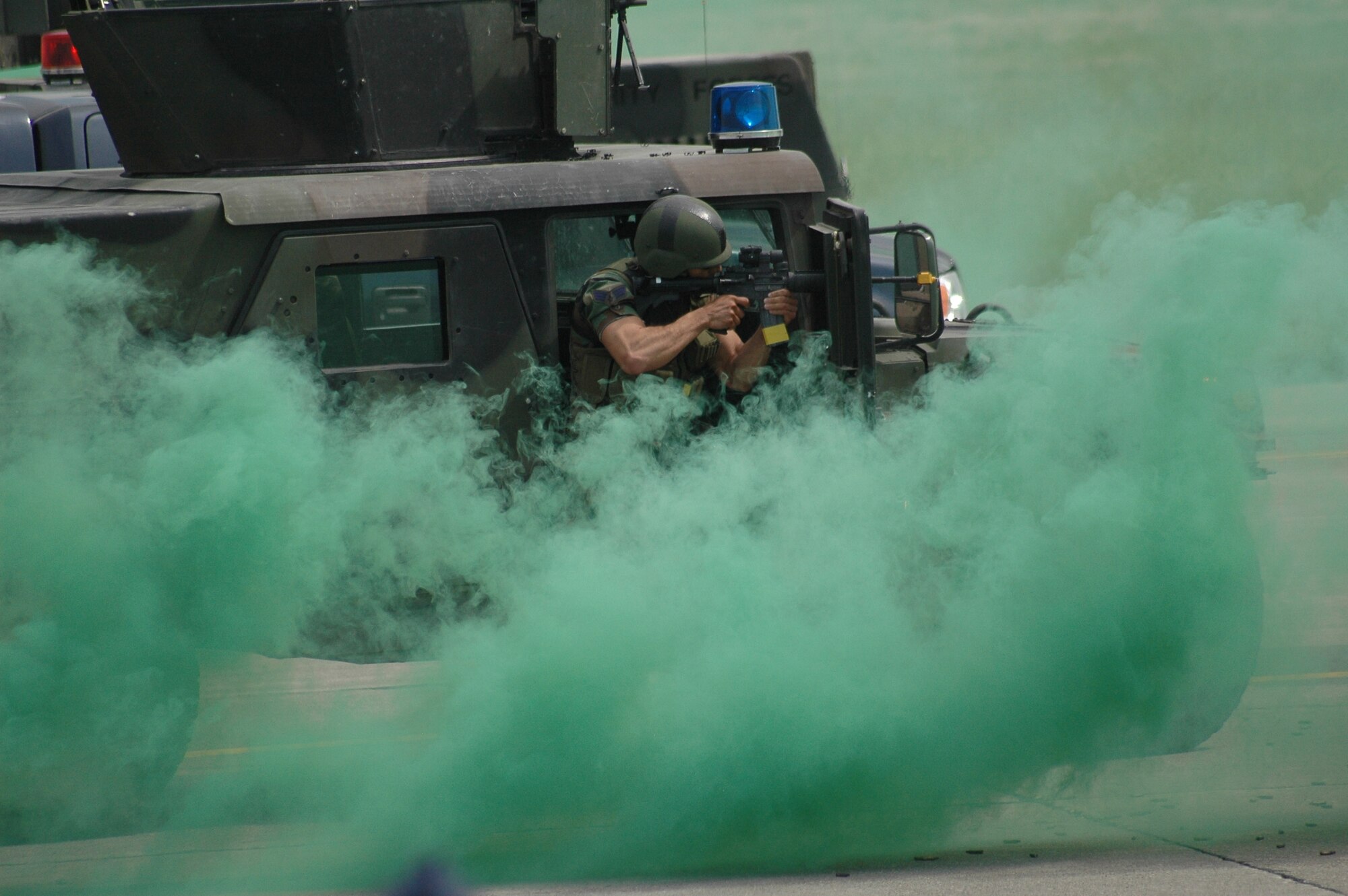 A security forces member demonstrates warfighting capabilities in a demonstration on the flightline during the open house and air show at Malmstrom Air Force Base May 20. The security forces were simulating an attack and response scenario. (U.S. Air Force photo by Airman 1st Class Emerald Ralston)