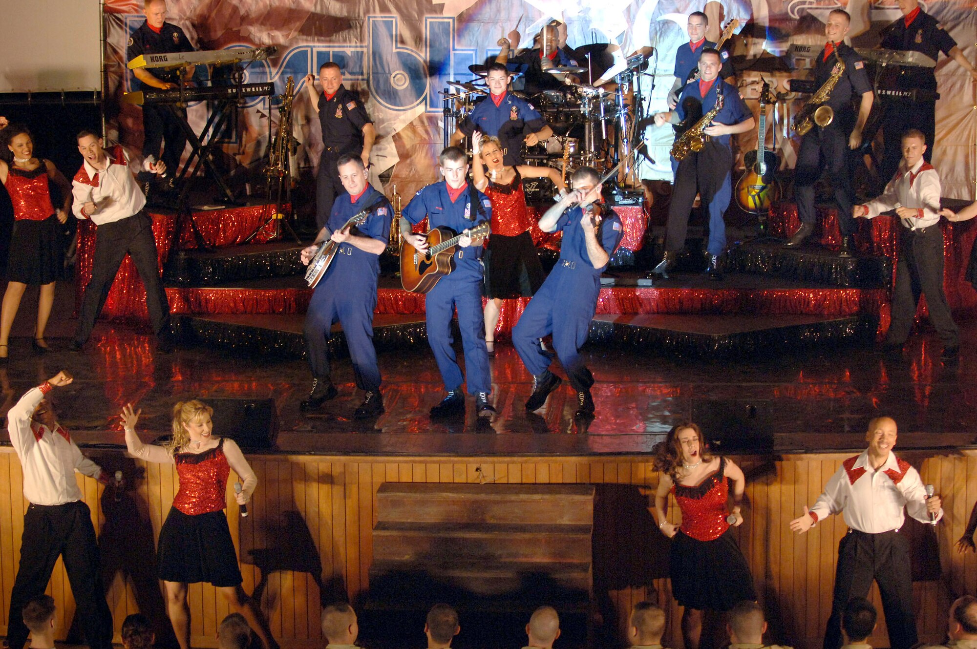 Members of Tops In Blue 2007 perform for servicemembers during a performance April 28 at Balad Air Base, Iraq. Center stage, plying the fiddle, is Capt. Alex Ruiz, who is a member of the 10th Missile Squadron at Malmstrom Air Force Base. Thirty eight active-duty Airmen with the Air Force's premier expeditionary entertainers set out in mid-April to kick off their 2007 tour singing and dancing their way through the area of responsibility. The group is not scheduled to perform in Great Falls until Jan. 22, 2008. (U.S. Air Force photo by Staff Sgt. Michael R. Holzworth)