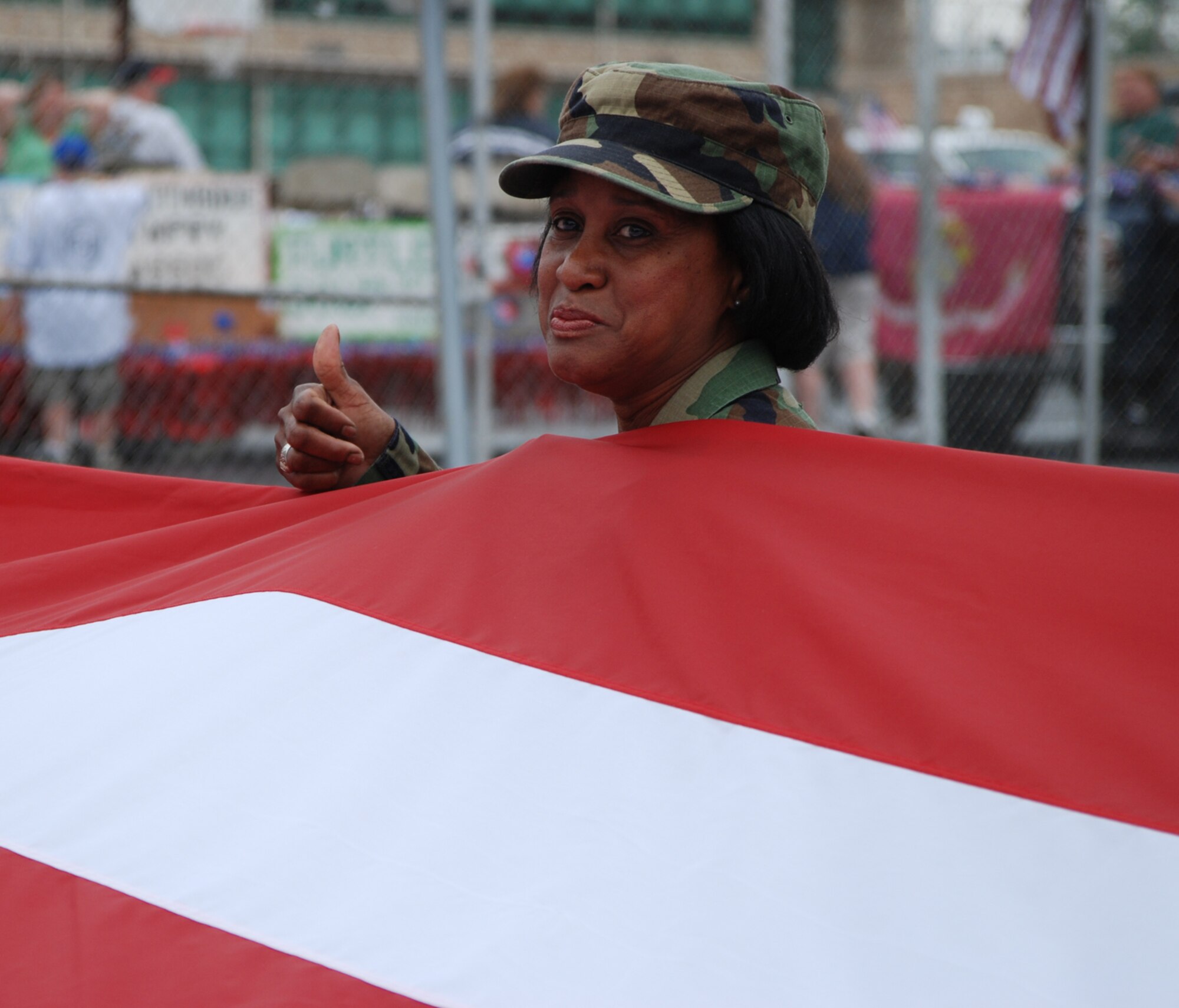 Tech. Sgt. Adrienne Palmer of the 932nd Airlift Wing, gives a thumbs up as she prepares to call cadence during the 2007 Belleville Memorial Day parade.