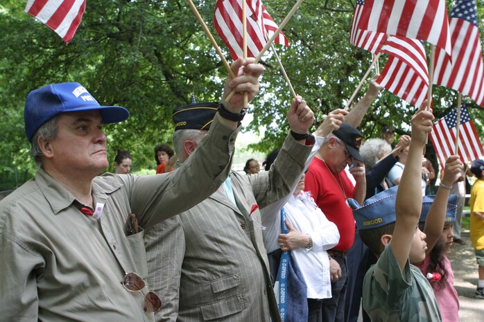 A firefighter with the New York City Fire Department watches Marines from Marine Corps Security Forces Battalion, based in Norfolk, Va., march through the streets of Brooklyn during the 7th Annual Brooklyn Memorial Day Parade on May 27.
