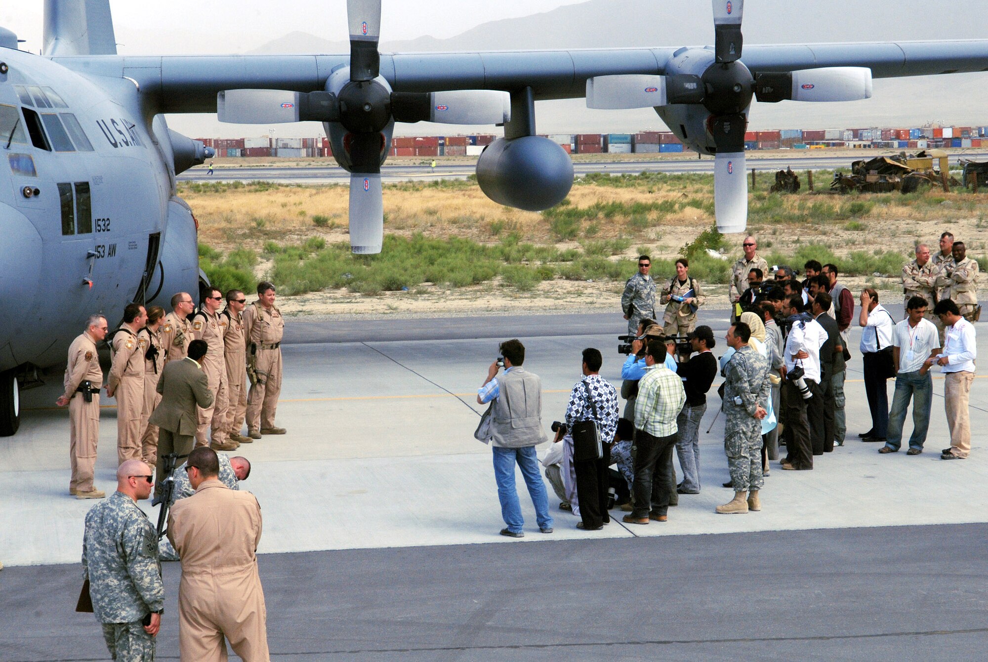 A C-130 aircrew from the 774th Expeditionary Airlift Squadron briefs a group of local Afghan media about their aircraft and its specific function and role in Operation ENDURING FREEDOM. The media day was aimed at informing the local Afghan media on the operations at Bagram and how the U.S. military is working alongside coalition partners to support and defend freedom in Afghanistan. (photo by Staff Sgt. Craig Seals)