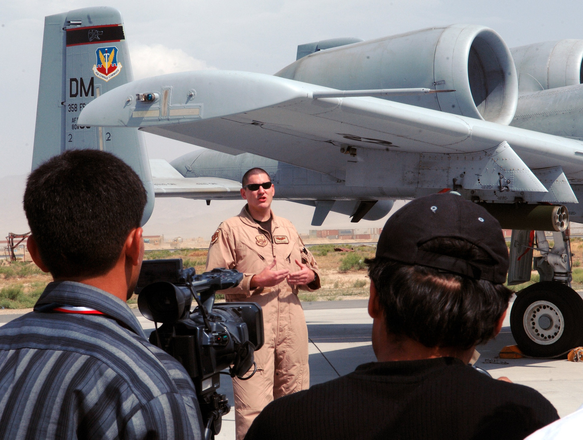 Capt. Doug Witmer, 354th Expeditionary Fighter Squadron A-10 pilot, explains his job as a pilot and the specific role his A-10 plays in the close air support mission here at Bagram Airfield, Afghanistan May 29. Capt. Witmer was one of several Airmen involved in a media event involving several local Afghan media aimed at informing them on the operations at Bagram and how the U.S. military is working alongside coalition partners to support and defend freedom in Afghanistan. (photo by Staff Sgt. Craig Seals)
