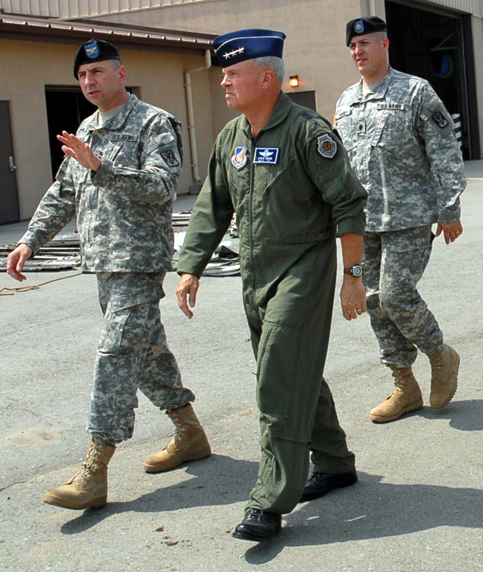 OSAN AIR BASE, Republic of Korea -- Lt. Gen. Stephen G. Wood, 7th Air Force commanding general/deputy commander U.S. Forces Korea, Col. John G. Rossi, 35th Air Defense Artillery Brigade commander, and Lt. Col. John R. Chavez, 1st Battalion, 43rd Air Defense Artillery commander, stroll through the Charlie Battery, 1-43 ADA work site.  Wood visited the brigade along with Air Force Chief Master Sgt. Raymond F. Allen III, 7th Air Force command chief master sergeant, to check the facilities that the 35th ADA BDE were using and to make sure that the ADA BDE was getting adequate space for their equipment. (U.S. Air Force photo by Pfc. Gretchen N. Goodrich)