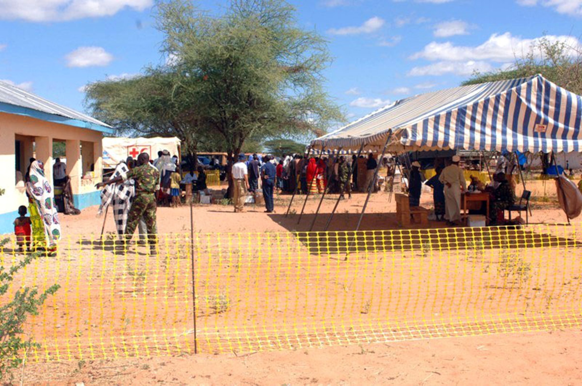 People prepare different stations during a Combined Joint Task Force - Horn of Africa Medical Civic Action Program in May in Kenya. CJTF-HOA servicemembers conducted the MEDCAP in the villages of Shimbir and Balichthrough a partnership with the Kenyan department of defense, which provided additional medical providers and logistical support. More than 1,000 people received healthcare as part of the project. (U.S. Air Force photo/Tech. Sgt. Carrie Bernard)