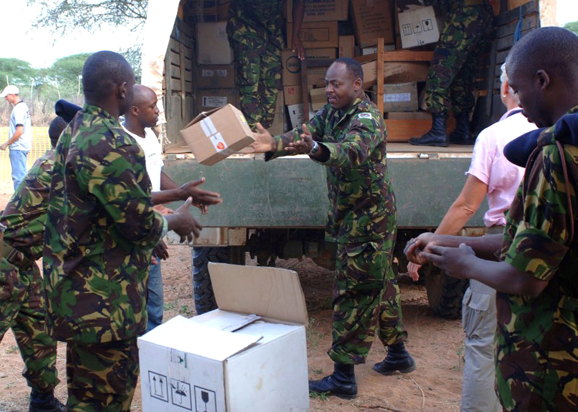 Kenyan department of defense servicemembers unload medical supplies during a Combined Joint Task Force - Horn of Africa Medical Civic Action Program in May in Kenya. CJTF-HOA servicemembers conducted the MEDCAP in the villages of Shimbir and Balich through a partnership with the Kenyan department of defense, which provided additional medical providers and logistical support. More than 1,000 people received healthcare as part of the project. (U.S. Air Force photo/Tech. Sgt. Carrie Bernard) 