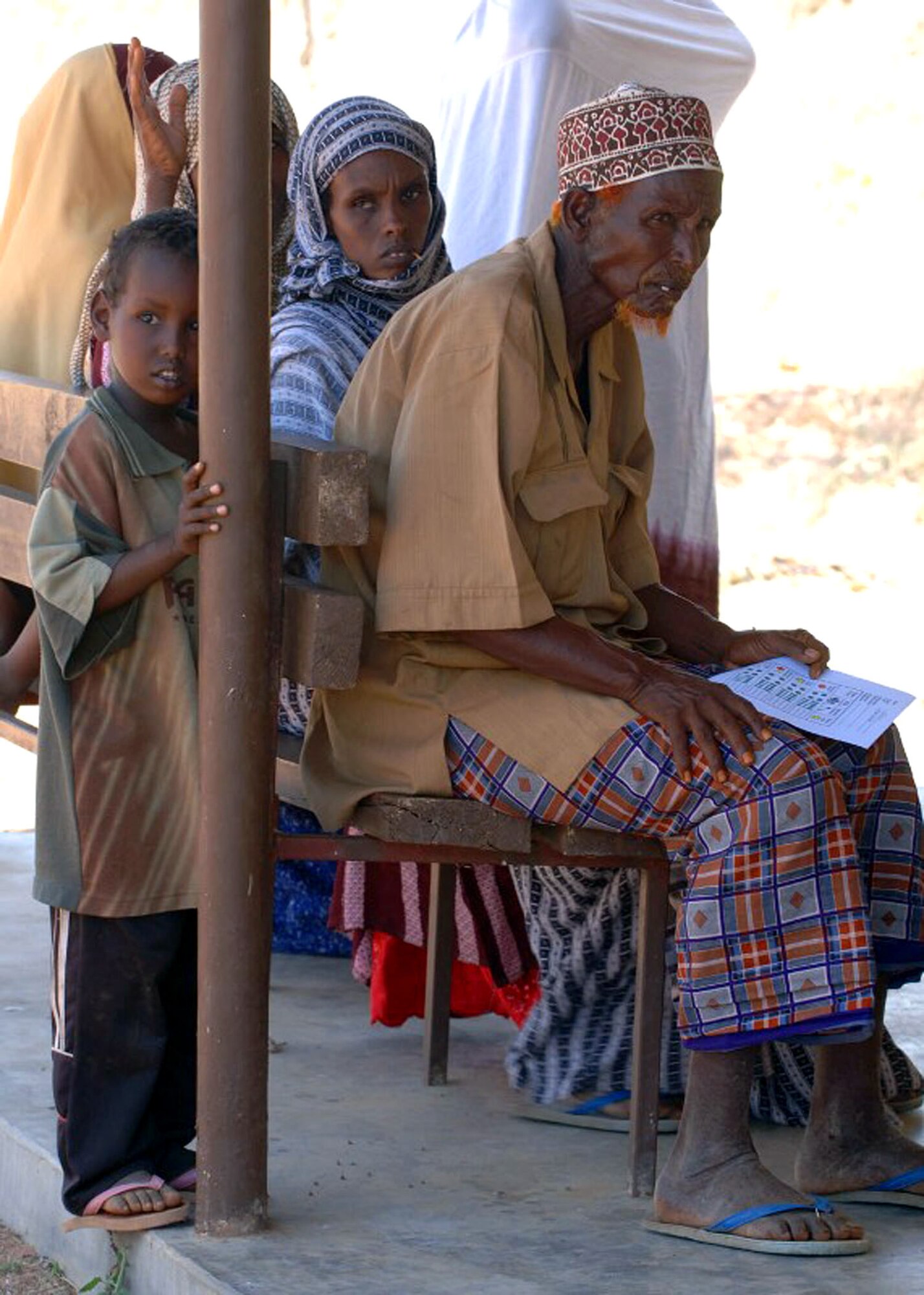 A family waits to be seen by a doctor during a Combined Joint Task Force - Horn of Africa Medical Civic Action Program in May in Kenya. CJTF-HOA servicemembers conducted the MEDCAP in the villages of Shimbir and Balich through a partnership with the Kenyan department of defense, which provided additional medical providers and logistical support. More than 1,000 people received healthcare as part of the project. (U.S. Air Force photo/Tech. Sgt. Carrie Bernard)