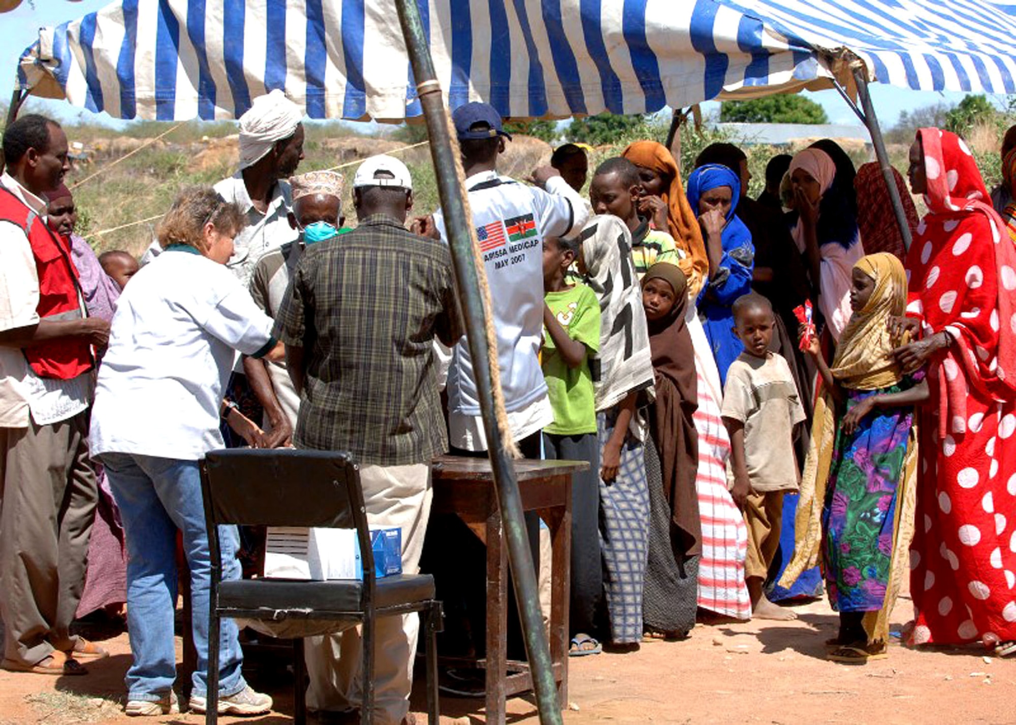 People line up to receive healthcare during a Combined Joint Task Force - Horn of Africa Medical Civic Action Program in May in Kenya. CJTF-HOA servicemembers conducted the MEDCAP in the villages of Shimbir and Balich through a partnership with the Kenyan department of defense, which provided additional medical providers and logistical support. More than 1,000 people received healthcare as part of the project. (U.S. Air Force photo/Tech. Sgt. Carrie Bernard) 
