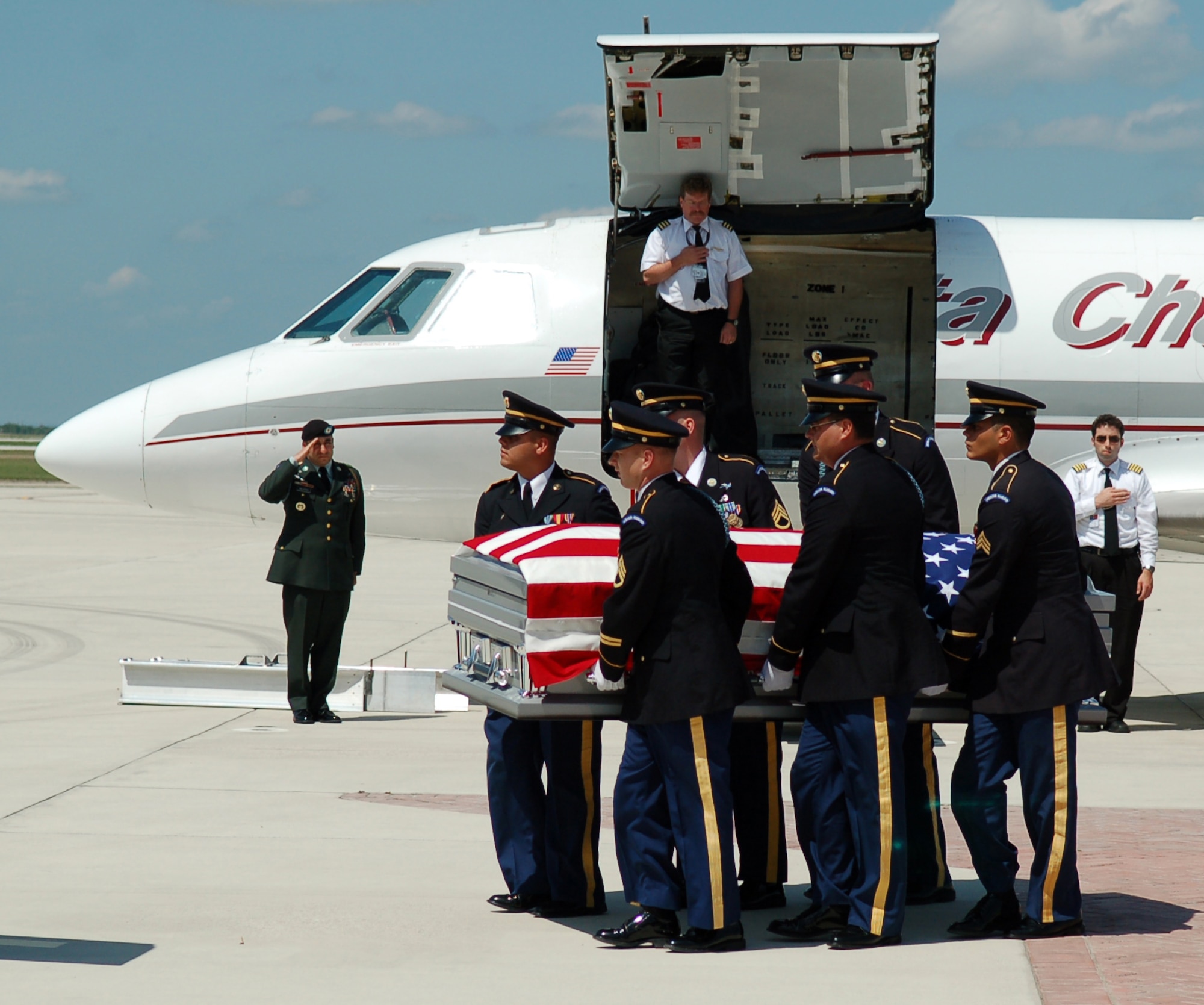 LAUGHLIN AIR FORCE BASE, Texas -- Honor Guard members from Fort Sam Houston carries the American Flag draped casket of U.S. Army Pvt. Oscar Sauceda Jr., 21. With a group of his family close by, a small charter plane carrying his body touched down at Laughlin May 29, to bring him home town of Del Rio, Texas. (U.S. Air Force photo by Staff Sgt. Austin May)


