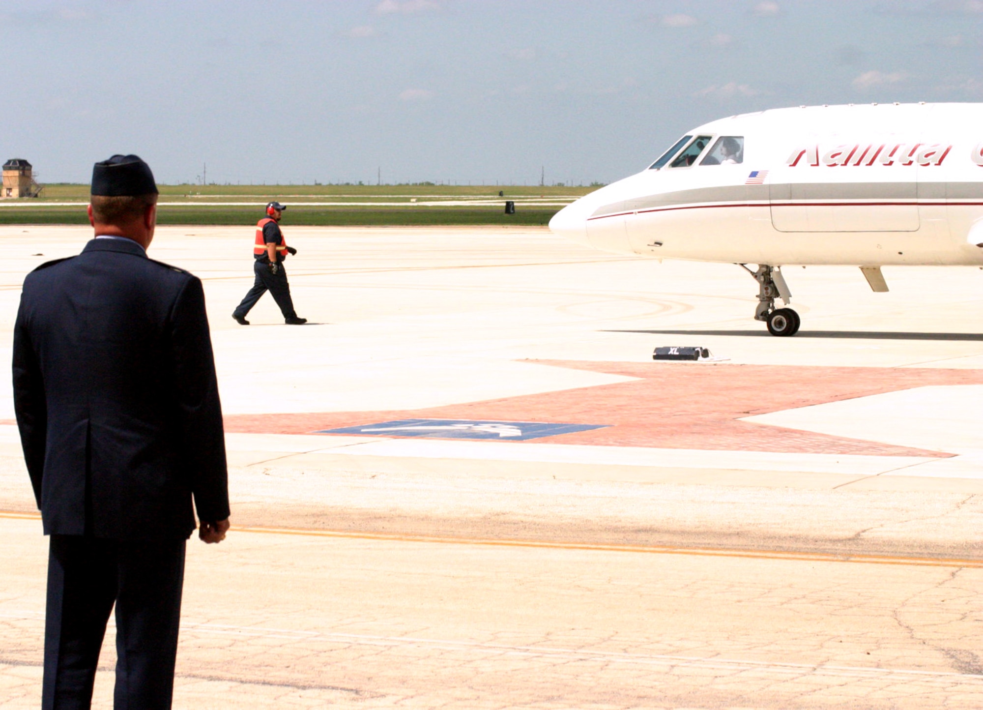 LAUGHLIN AIR FORCE BASE, Texas -- Col. Dan Clark watches as a small charter plane taxis U.S. Army Pvt. Oscar Sauceda Jr's, 21, remains. The infantryman was killed May 22 in Baghdad by small arms fire, and touched down at Laughlin May 28. (U.S. Air Force photo by Airman Sara Csurilla)