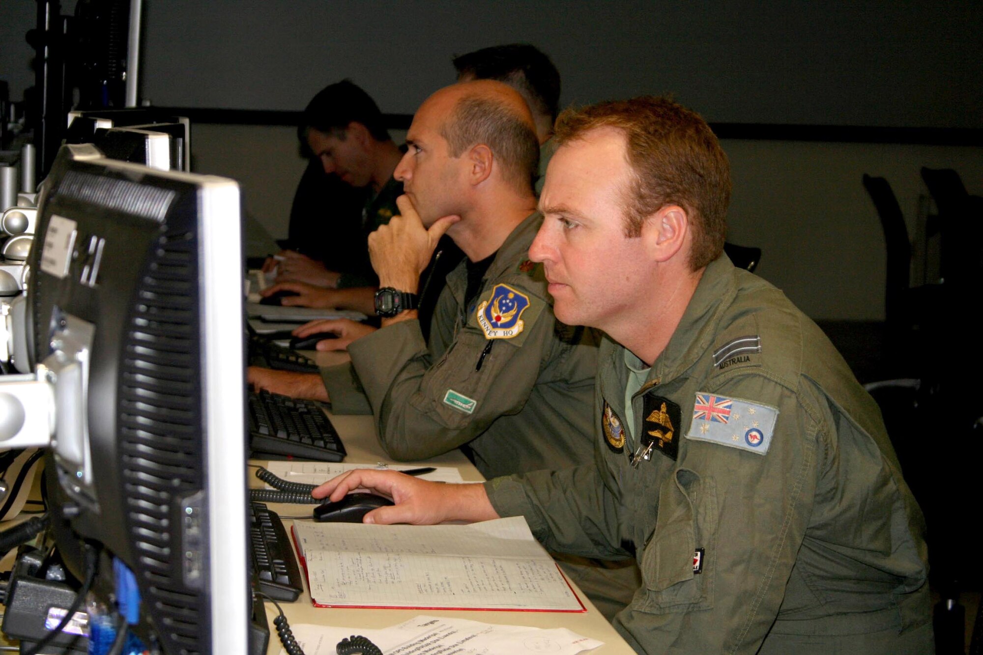 Royal Australian Air Force Flight Lt. Leo Lochran and Maj. Paul Arbizzani work in the Dynamic Targeting Cell on the Air Operations Center operations floor during Exercise Talisman Saber '07 May 24 at Hickam Air Force Base, Hawaii. Major Arbizzani is assigned to the 613th Air and Space Operations Center Combat Operations Division. (U.S. Air Force photo/Capt. Yvonne Levardi) 
