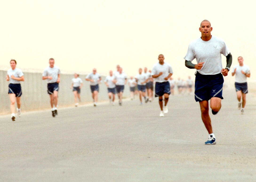 Tech. Sgt. Rudy Moreno leads other members of the 407th Expeditionary Group down the flightline during a 5K run, which is the kickoff to a full day of events celebrating Memorial Day May 28 at Ali Air Base, Iraq. Memorial Day, originally named Decoration Day, was instituted May 5, 1866, in Waterloo, N.Y., to honor the fallen Union Soldiers of the Civil War. After World War I it was expanded to include all military members that have given the ultimate sacrifice for their country. Sergeant Moreno is assigned to the 407th Expeditionary Civil Engineer Squadron. (U.S. Air Force photo/Master Sgt. Robert W. Valenca) 