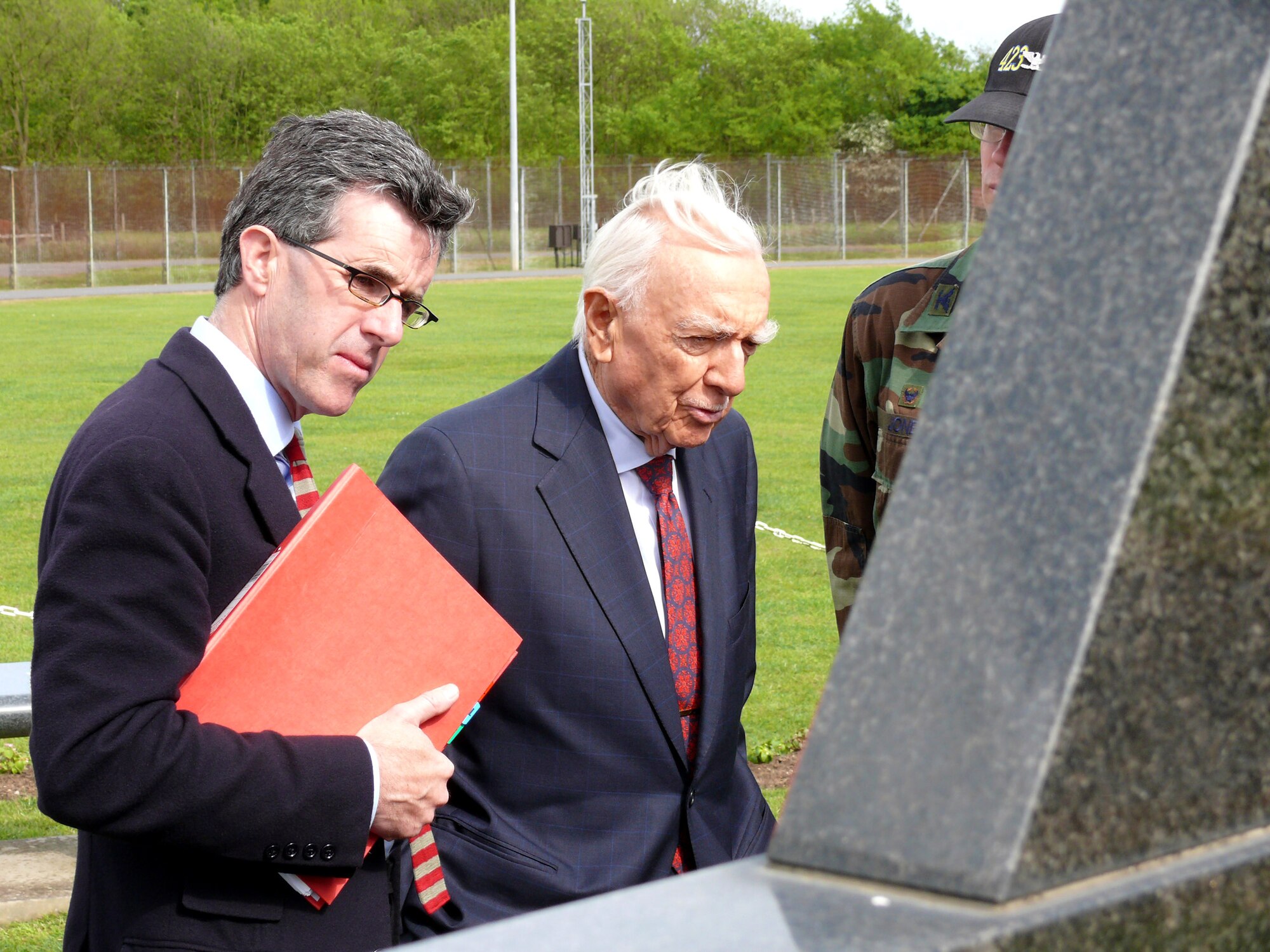 Journalist Walter Cronkite (center) looks at the 303rd Bomb Group memorial along with Alastair Layzell May 29 at Royal Air Force Molesworth, England. Mr. Layzell is a Colonial Pictures producer. The two are working on a special that will feature Capt. Donald Stockton and the 303rd Bomb Group. (U.S. Air Force photo/Tech. Sgt. Scott Wakefield)
