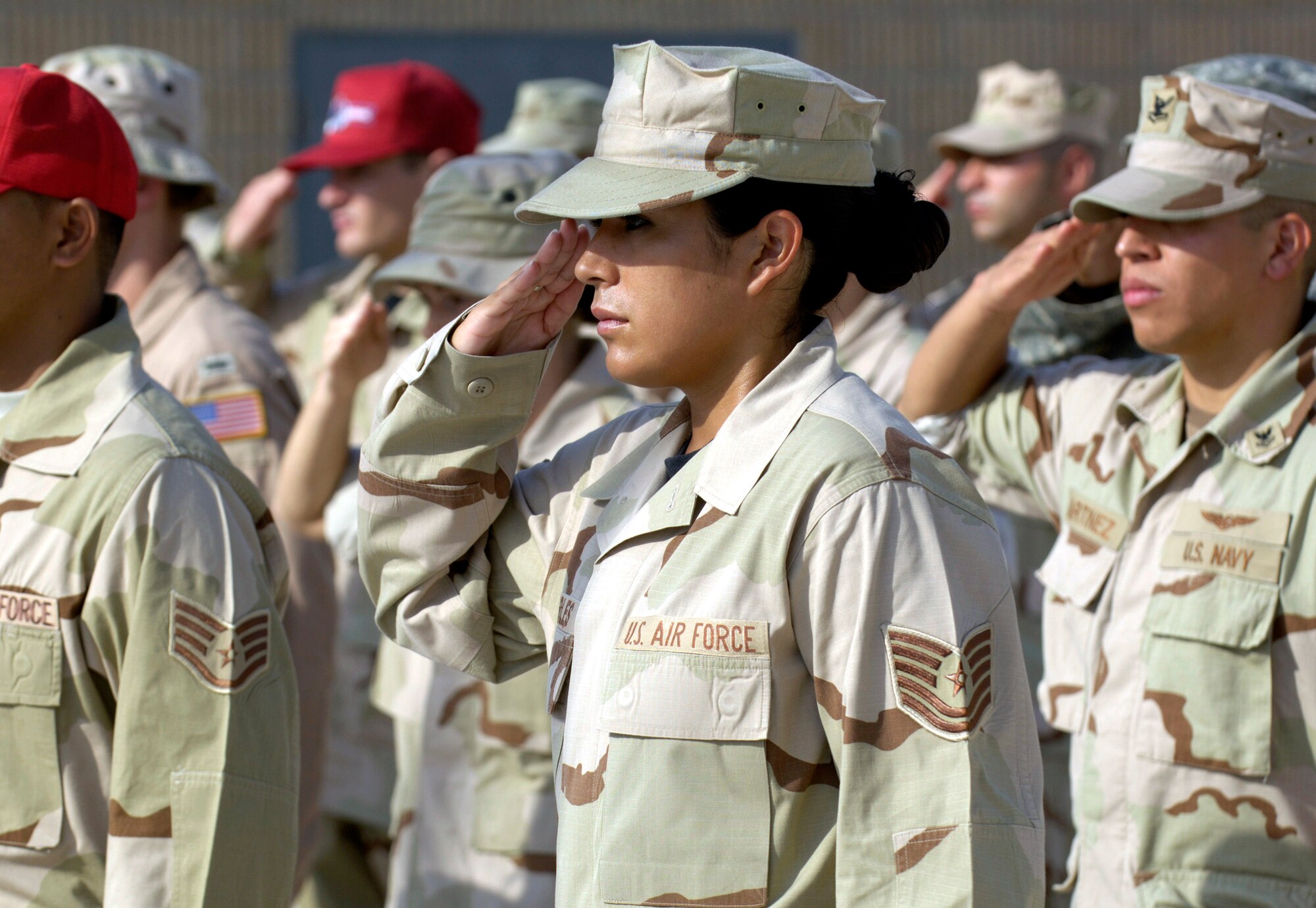 Tech. Sgt. Maria Robles pays honor to the flag as coalition partners from several countries gathered May 28 at this deployed location in Southwest Asia to participate in a Memorial Day ceremony. Sergeant Robles is a hospital administrative craftsman deployed from Keesler Air Force Base, Miss., and hails from Harlingen, Texas. Originally known as Decoration Day, Memorial Day ceremonies are a time to pay tribute to servicemembers who have paid the ultimate sacrifice in securing freedom. (U.S. Air Force photo/Master Sgt. Jim Varhegyi) 
