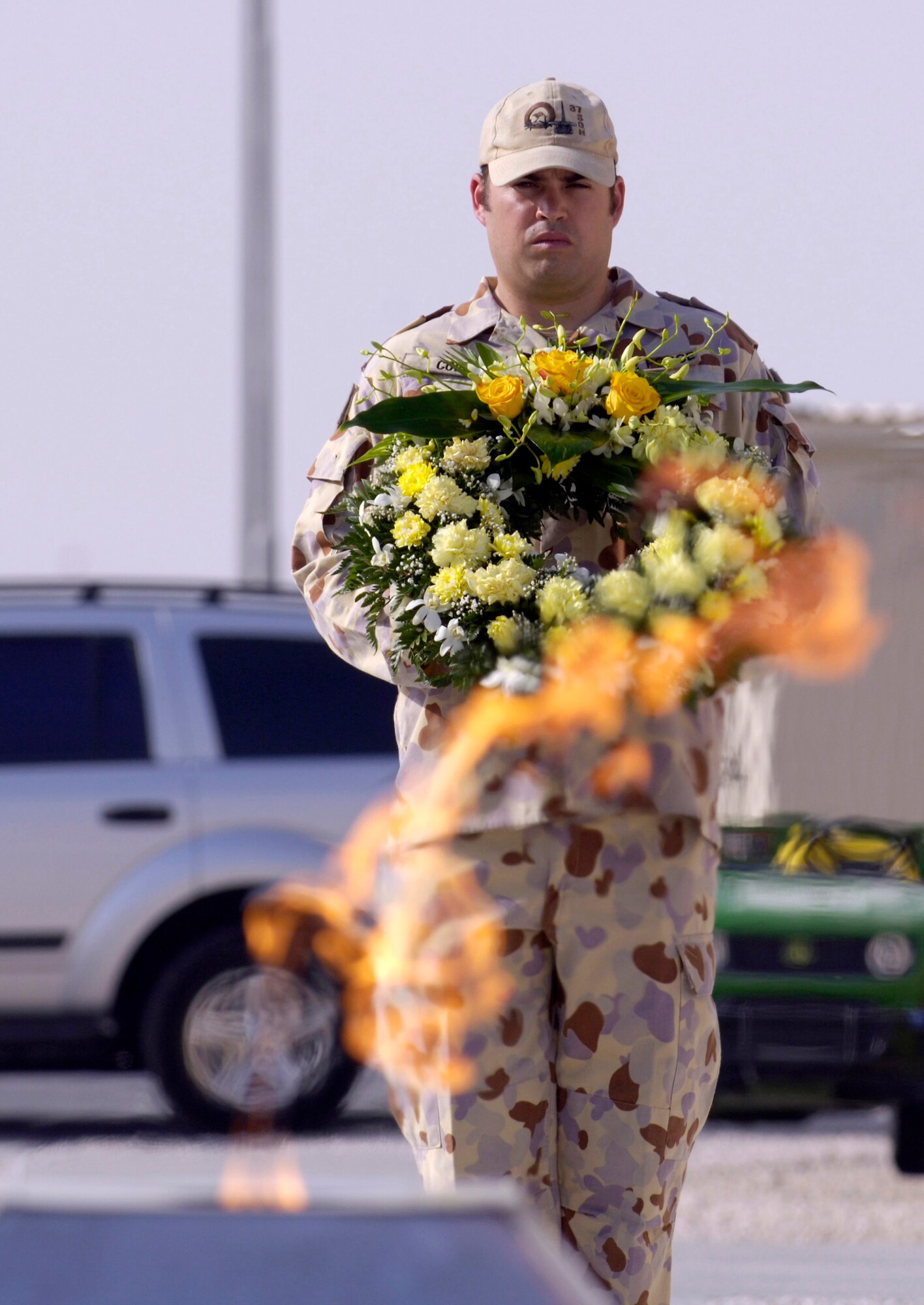 Australian Defense Force Sgt. Scott Copland bears a wreath as coalition partners from several countries gathered May 28 at this deployed location in Southwest Asia to participate in a Memorial Day ceremony. Originally known as Decoration Day, Memorial Day ceremonies are a time to pay tribute to servicemembers who have paid the ultimate sacrifice in securing freedom. (U.S. Air Force photo/Master Sgt. Jim Varhegyi) 
