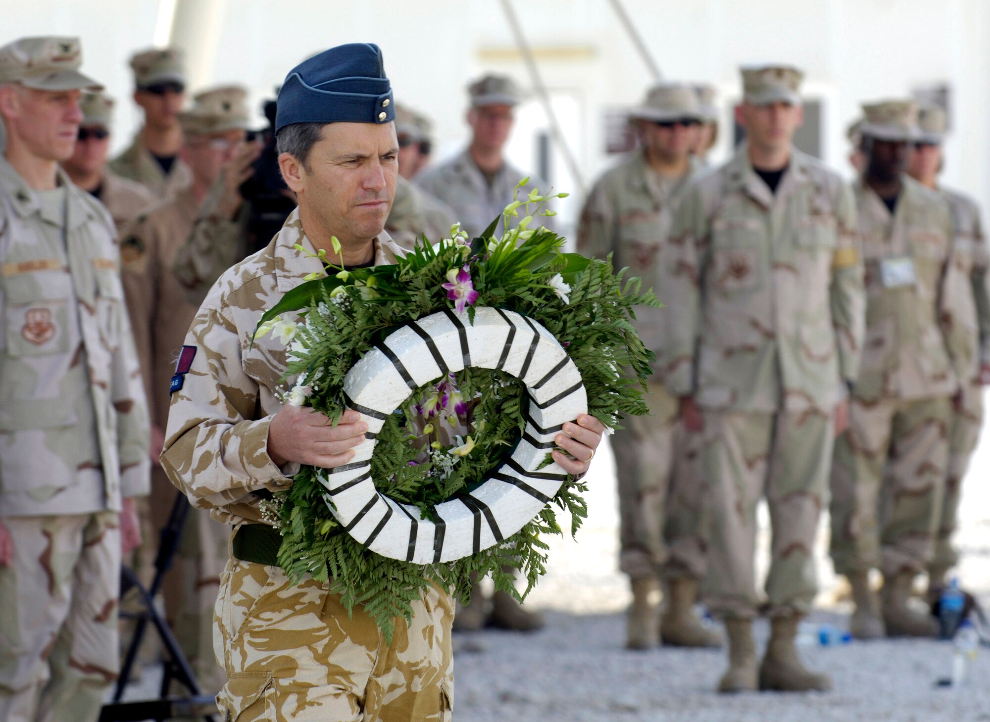 An Australian coalition partner lays a wreath May 28 at this deployed location in Southwest Asia during a Memorial Day ceremony. Originally known as Decoration Day, Memorial Day ceremonies are a time to pay tribute to servicemembers who have paid the ultimate sacrifice in securing freedom. (U.S. Air Force photo/Master Sgt. Jim Varhegyi) 
