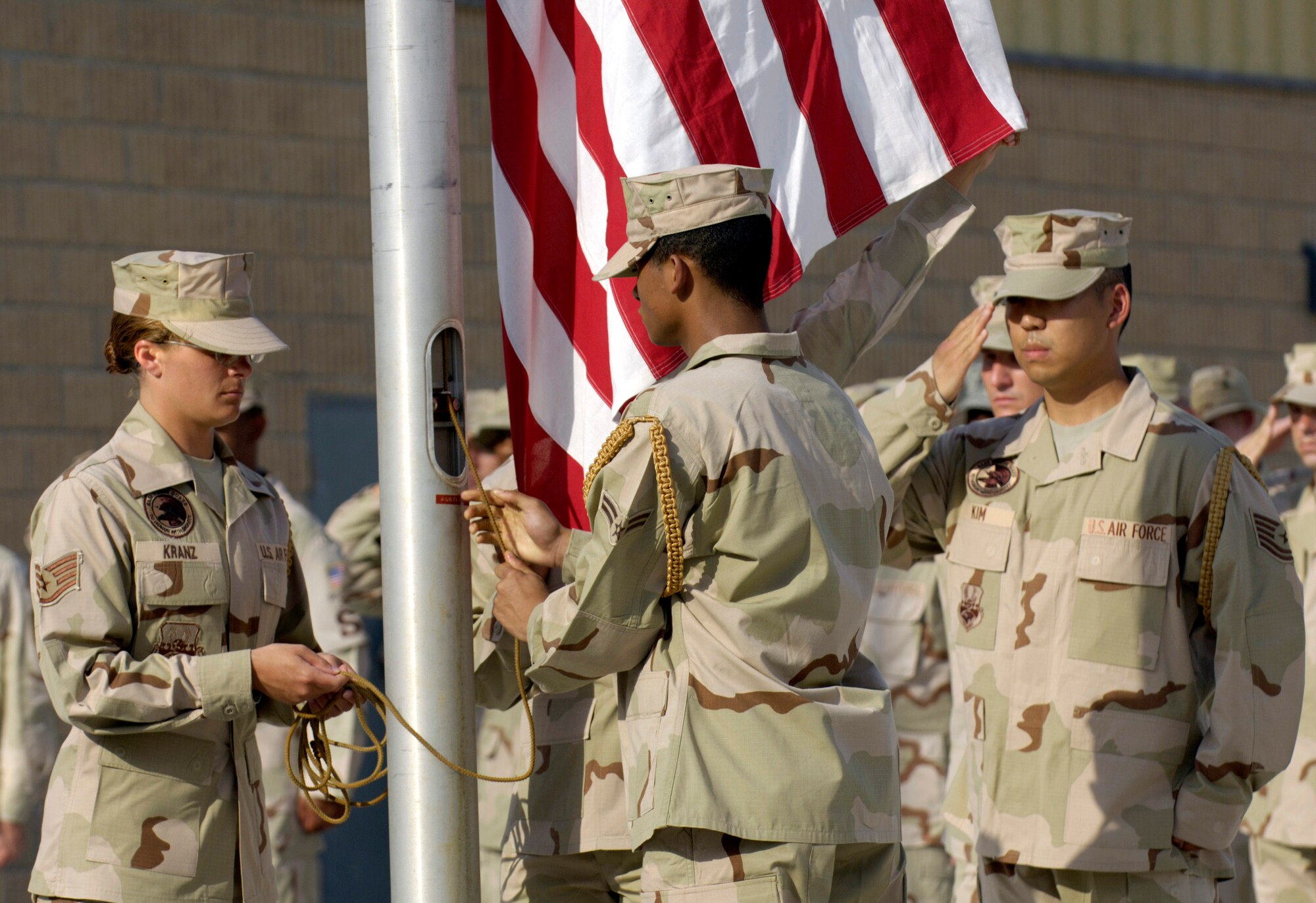 An Air Force honor guard raises the flag as coalition partners from several countries gathered May 28 at this deployed location in Southwest Asia to participate in a Memorial Day ceremony. Originally known as Decoration Day, Memorial Day ceremonies are a time to pay tribute to servicemembers who have paid the ultimate sacrifice in securing freedom. (U.S. Air Force photo/Master Sgt. Jim Varhegyi) 
