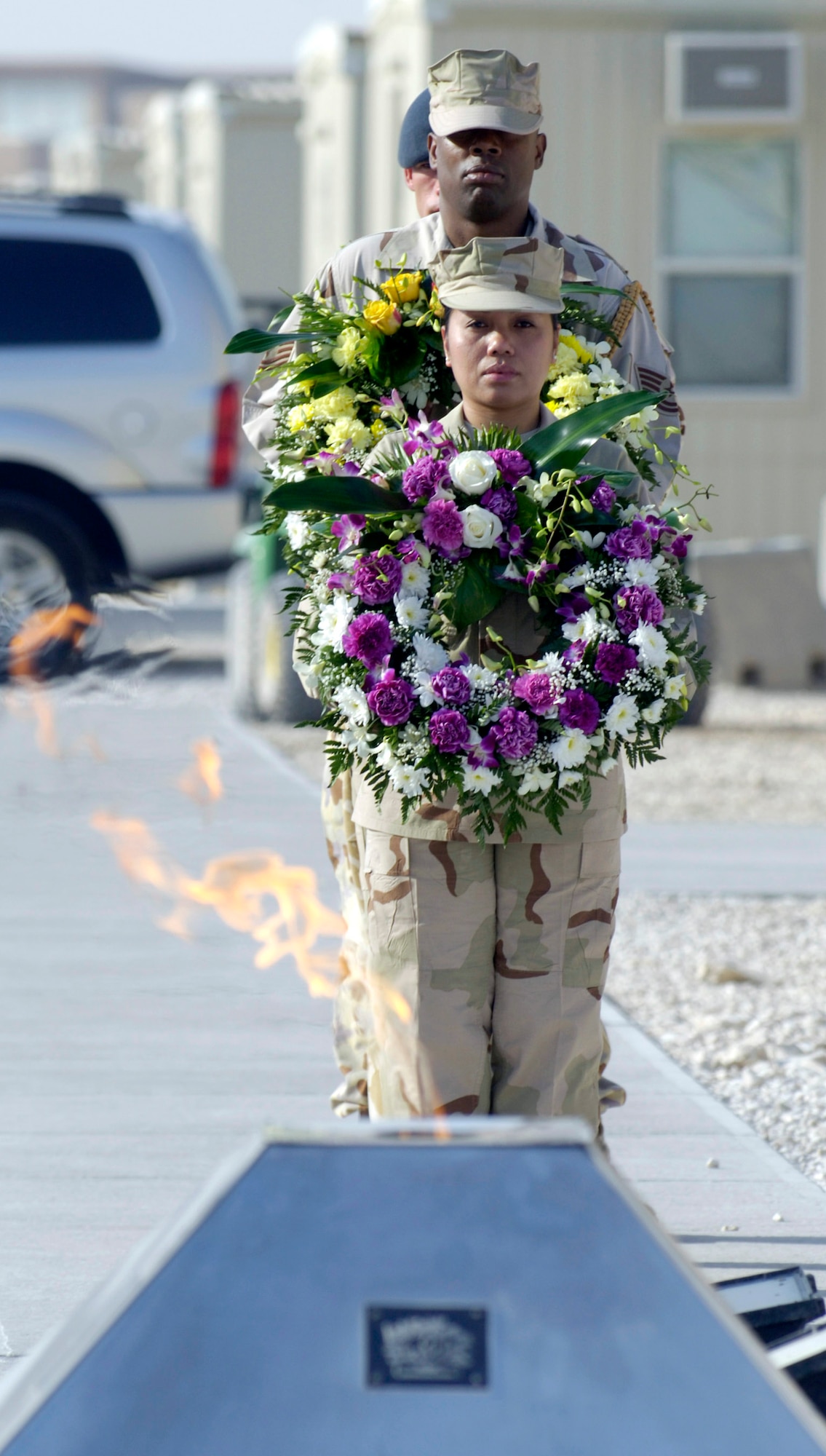 Master Sgt. Juliet Alonso and a multinational wreath bearing team prepare to lay wreaths as coalition partners from several countries gathered May 28 at this deployed location in Southwest Asia to participate in a Memorial Day ceremony. Sergeant Alonso is a services specialist deployed from Dobbins Air Reserve Base, Ga., and hails from Centerville, Ga. Originally known as Decoration Day, Memorial Day ceremonies are a time to pay tribute to servicemembers who have paid the ultimate sacrifice in securing freedom. (U.S. Air Force photo/Master Sgt. Jim Varhegyi) 
