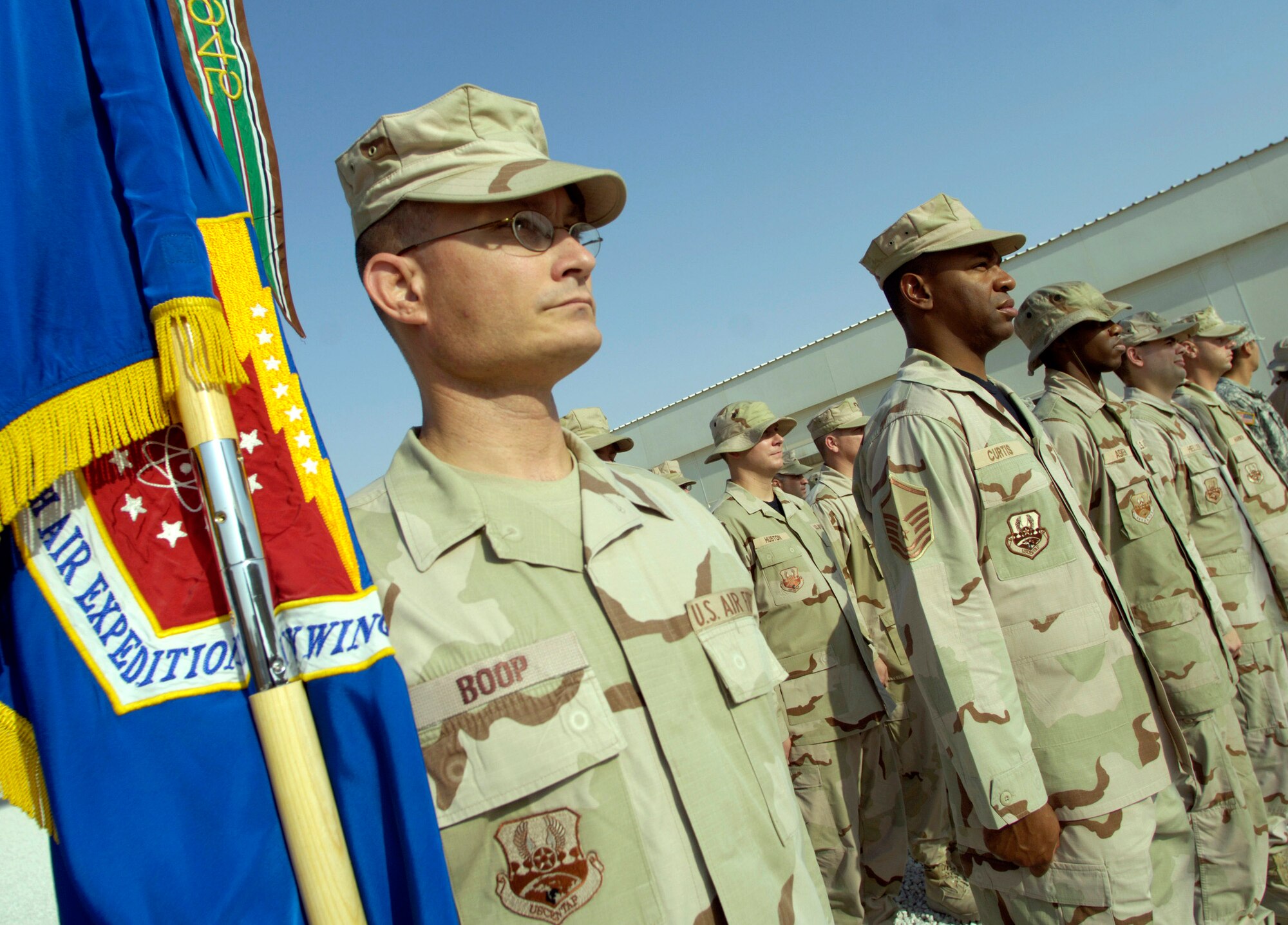 Master Sgt. Michael Boop serves as flag bearer as coalition partners from several countries gathered May 28 at this deployed location in Southwest Asia to participate in a Memorial Day ceremony. Originally known as Decoration Day, Memorial Day ceremonies are a time to pay tribute to servicemembers who have paid the ultimate sacrifice in securing freedom. (U.S. Air Force photo/Master Sgt. Jim Varhegyi)