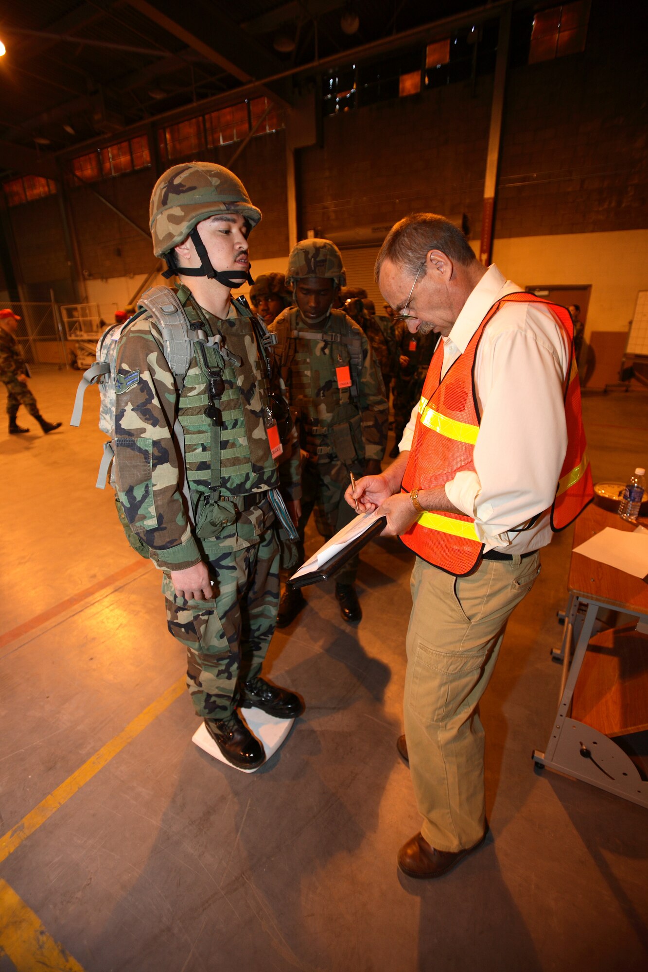 A base readiness manager weighs an Airman for deployment during a Phase 1 exercise here May 23. (Photo by Jet Fabara)