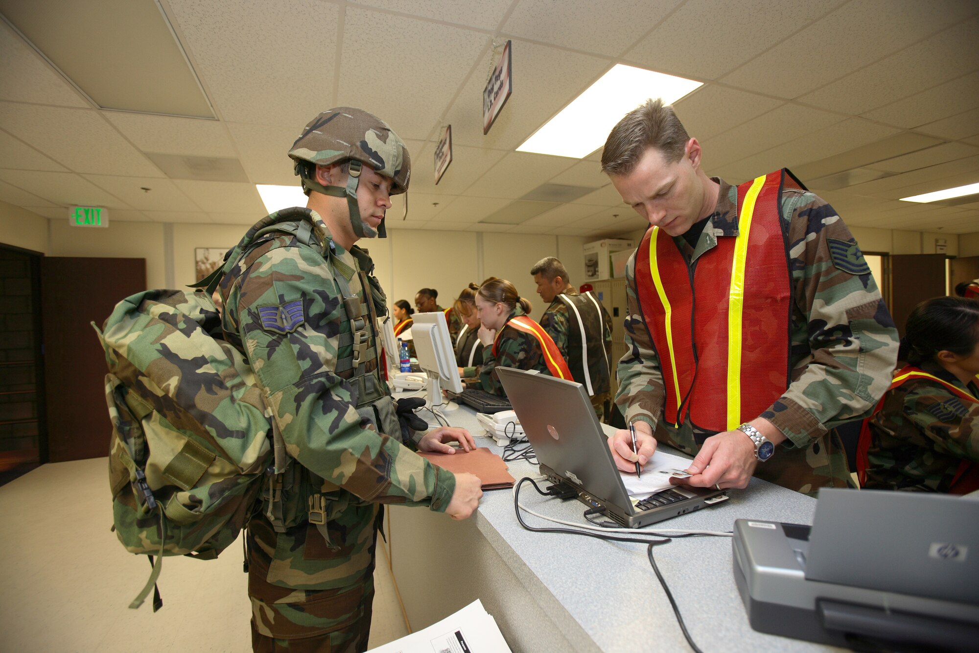 Tech. Sgt. David Boydston, 95th Medical Operations Squadron primary care flight noncommissioned officer in charge for the family practice element, processes an Airman for deployment during a Phase 1 exercise here May 23. (Photo by Jet Fabara)