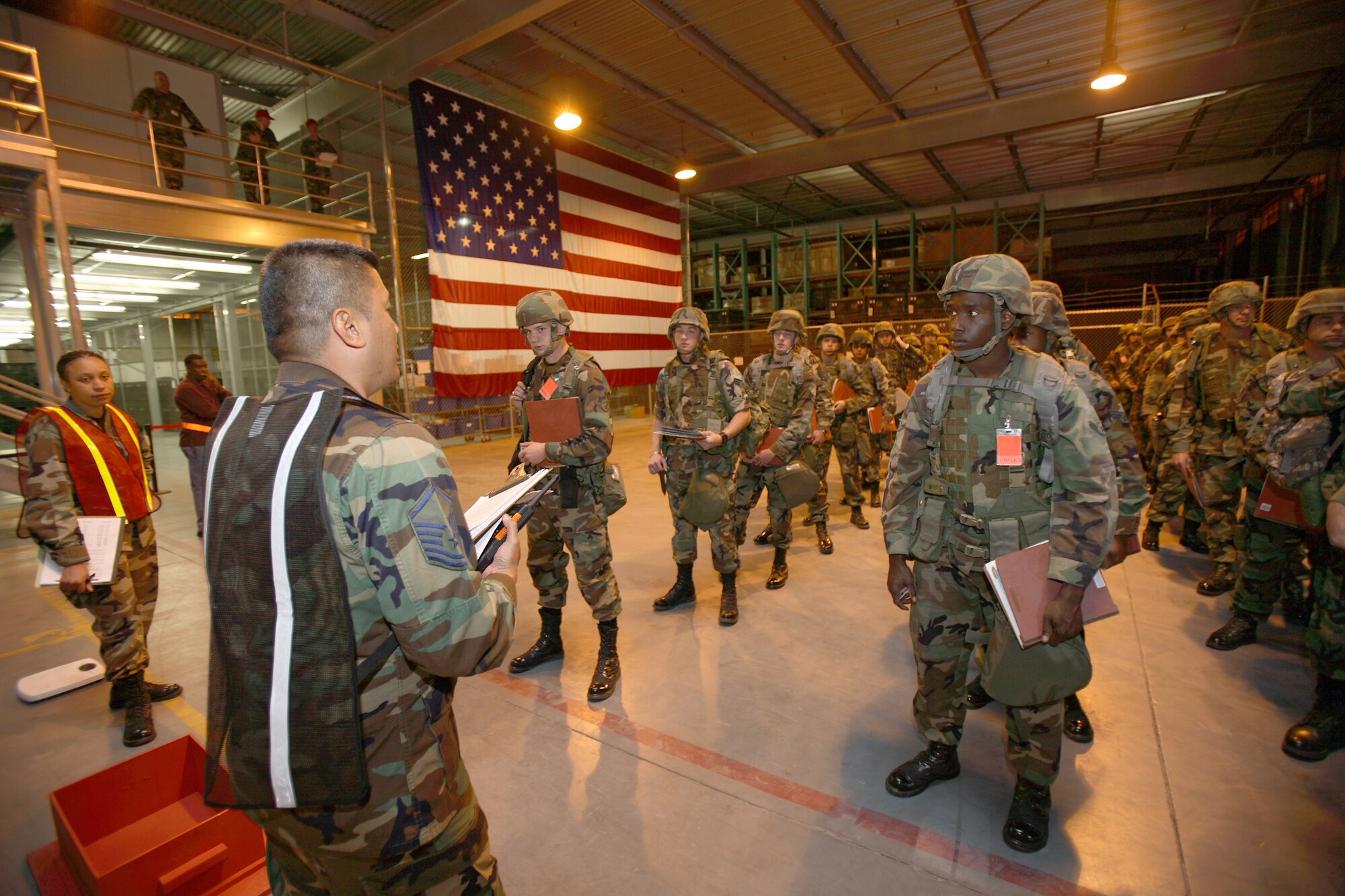 A base readiness manager checks a passenger manifest at the deployment facility during Phase I exercise here May 23. (Photo by Jet Fabara)