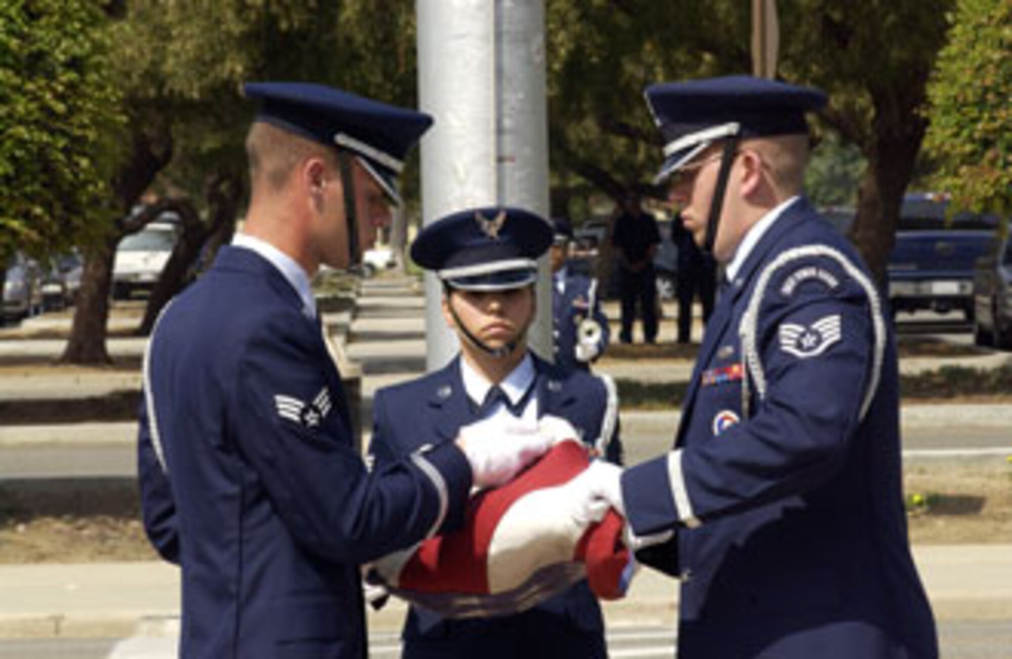 Senior Airman John Ahrens (from left), Staff Sgt. Dawn Perez and Staff Sgt. Kyle Hollingsworth, members of the 452nd AMW color guard team, led by Master Sgt. Octavio Ortiz, fold the colors at the end of the ceremony. Representatives Several hundred Airmen showed up in front of the 452nd Air Mobility Wing headquarters building Sunday afternoon to participate in a very special commander’s call at March Air Reserve Base. Standing in formation were representatives from every unit on base as well as the local Civil Air Patrol squadrons. Brig. Gen. James Melin, the 452nd commander, took time to address his troops as well as speak about the upcoming Memorial Day and its significance to all of us who proudly wear a military uniform. This time honored tradition of holding commander’s call at Wing HQ has years of historic value dating back to the days when past commanders -- including General Henry “Hap” Arnold, who took command of March Field in 1931 -- used to address Airmen from the balcony of the HQ building. (U.S. Air Force photo by Tech. Sgt. Michael Blair)