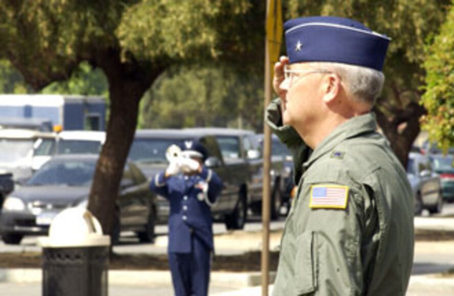 The 452nd AMW commander, Brig. Gen. James Melin, salutes as a bugler plays taps. Several hundred Airmen showed up in front of the 452nd Air Mobility Wing headquarters building Sunday afternoon to participate in a very special commander’s call at March Air Reserve Base. Standing in formation were representatives from every unit on base as well as the local Civil Air Patrol squadrons. Brig. Gen. James Melin, the 452nd commander, took time to address his troops as well as speak about the upcoming Memorial Day and its significance to all of us who proudly wear a military uniform. This time honored tradition of holding commander’s call at Wing HQ has years of historic value dating back to the days when past commanders -- including General Henry “Hap” Arnold, who took command of March Field in 1931 -- used to address Airmen from the balcony of the HQ building. (U.S. Air Force photo by Tech. Sgt. Michael Blair)