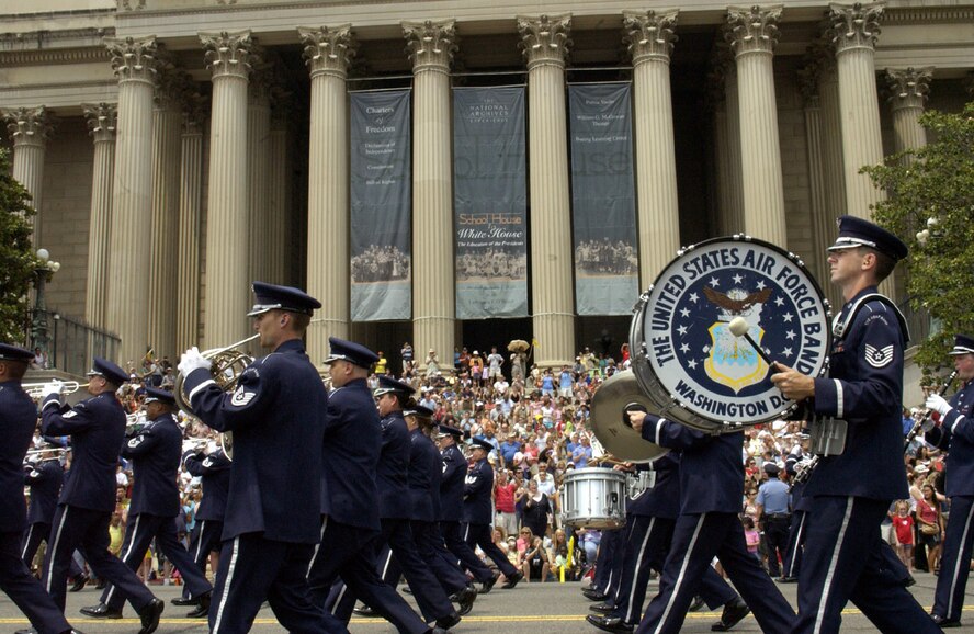 Airmen from the U.S. Air Force Band march in front of the National Archives during the National Memorial Day Parade Monday. The parade highlighted the Air Force's 60th anniversary as a separate service and featured several well-known Airmen. Maj. Gen. Robert L. Smolen, Air Force District of Washington commander, served as the grand marshall for the parade; Secretary of the Air Force Michael Wynne and Chief Master Sgt of the Air Force Rodney McKinley attended as well. In addition, members from all services represented the efforts of fighting men and women through every war and conflict since the early days of the nation. (U.S. Air Force photo by Staff Sgt. J.G. Buzanowski)