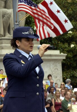 Maj. Kat Strus, from the Air Force District of Washington A1 office, sings the "Star-Spangled Banner" at the National Memorial Day Parade Monday. The parade highlighted the Air Force's 60th anniversary as a separate service and featured Airmen from the U.S. Air Force Band and Honor Guard. Maj. Gen. Robert L. Smolen, Air Force District of Washington commander, served as the grand marshall for the parade; Secretary of the Air Force Michael Wynne and Chief Master Sgt of the Air Force Rodney McKinley attended as well. In addition, members from all services represented the efforts of fighting men and women through every war and conflict since the early days of the nation. (U.S. Air Force photo by Staff Sgt. J.G. Buzanowski) 