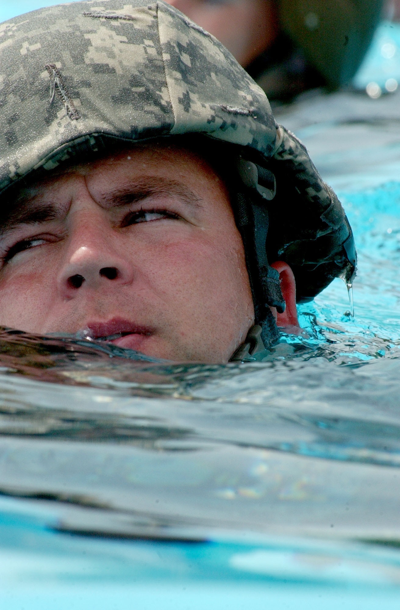 Staff Sgt. Brian Grishaw, a member of  Soto Cano Air Base Search and Rescue team, keeps his head above water during combat water survival/drownproofing training at the base pool May 22, 2007.  U.S. Air Force photo by Senior Airman Shaun Emery.                            