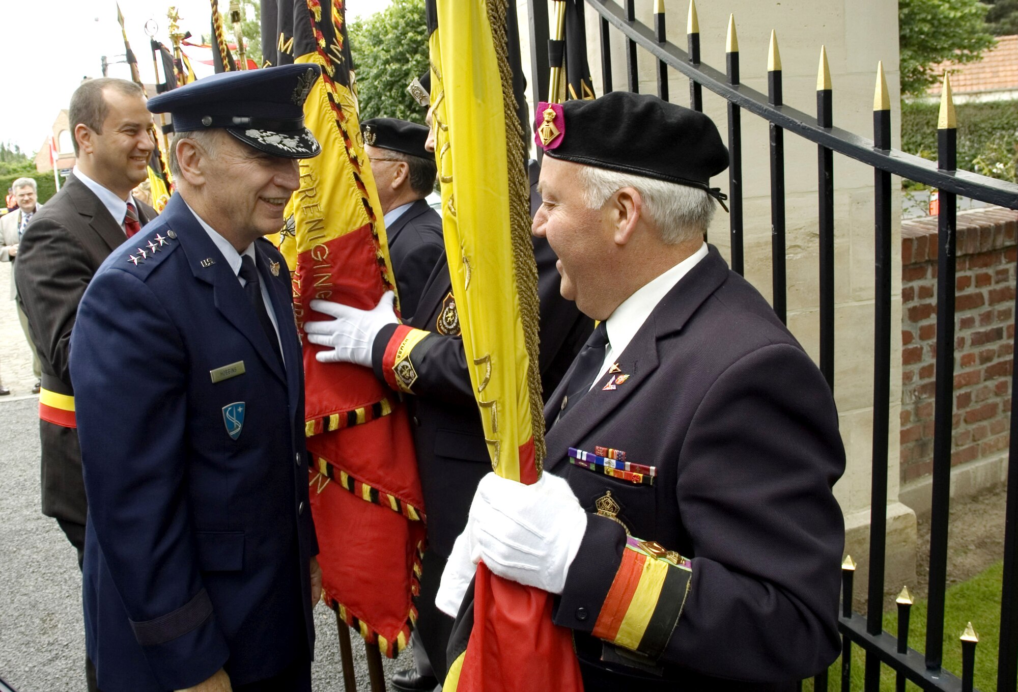 Gen. William T. Hobbins greets a ceremony participant May 27 at Flanders Field, Belgium. General Hobbins, the commander of U.S. Air Forces in Europe, paid tribute to the 368 servicemembers buried there who died in battle while liberating Belgium during World War II. (U.S. Air Force photo/Staff Sgt. Dan Bellis) 
