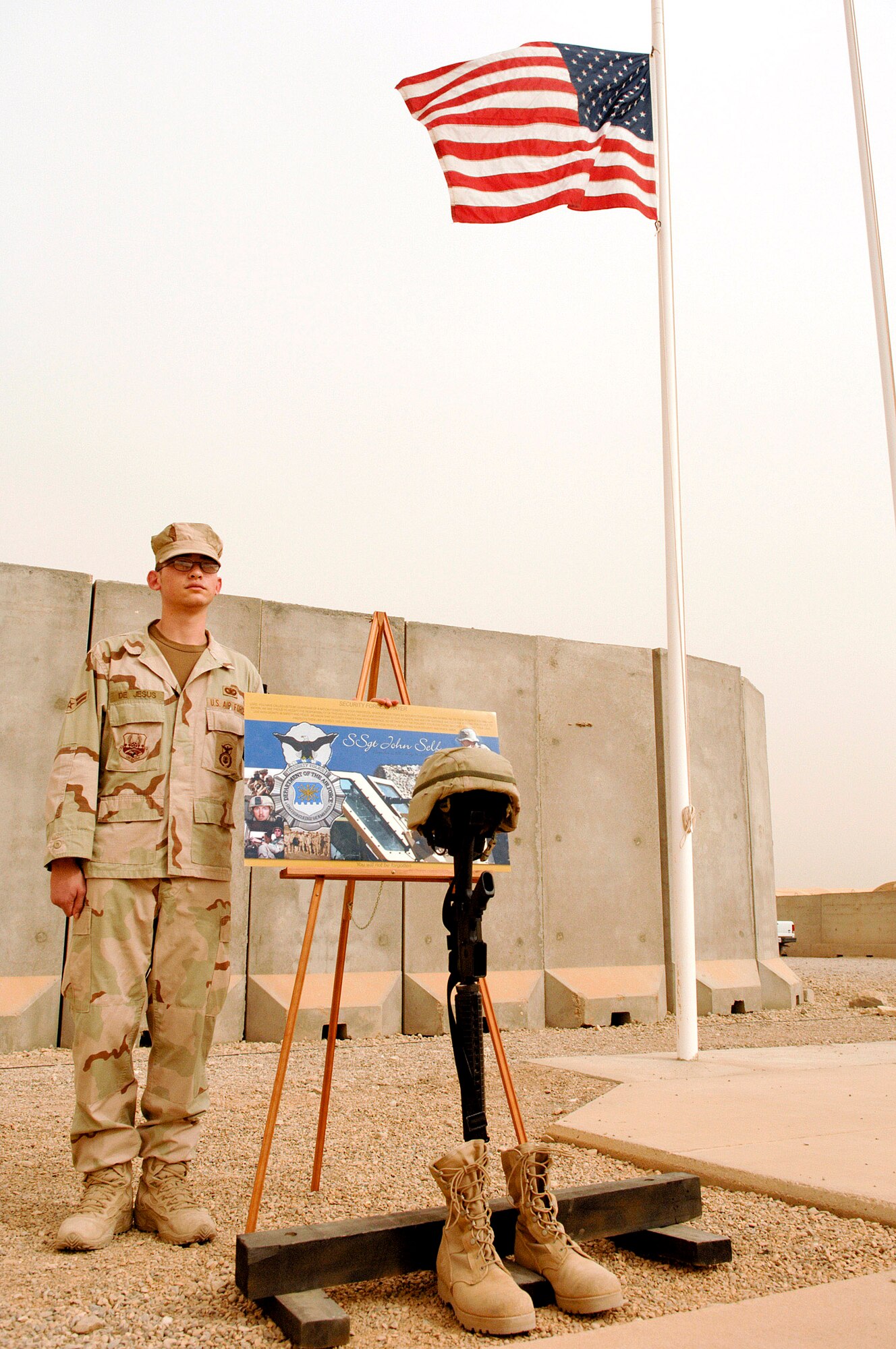 Airman 1st Class Zachary DeJesus, 407th Expeditionary Security Forces Squadron stands watch over the memorial of Staff Sgt. John Self during a fallen Airmen ceremony May 28 at Ali Air Base, Iraq. Sergeant Self, a security forces member assigned to the 732nd Expeditionary Security Forces Squadron at Camp Bucca, Iraq, was killed May 14 by an improvised explosive device while on patrol. (U.S. Air Force photo/Master Sgt. Robert W. Valenca)