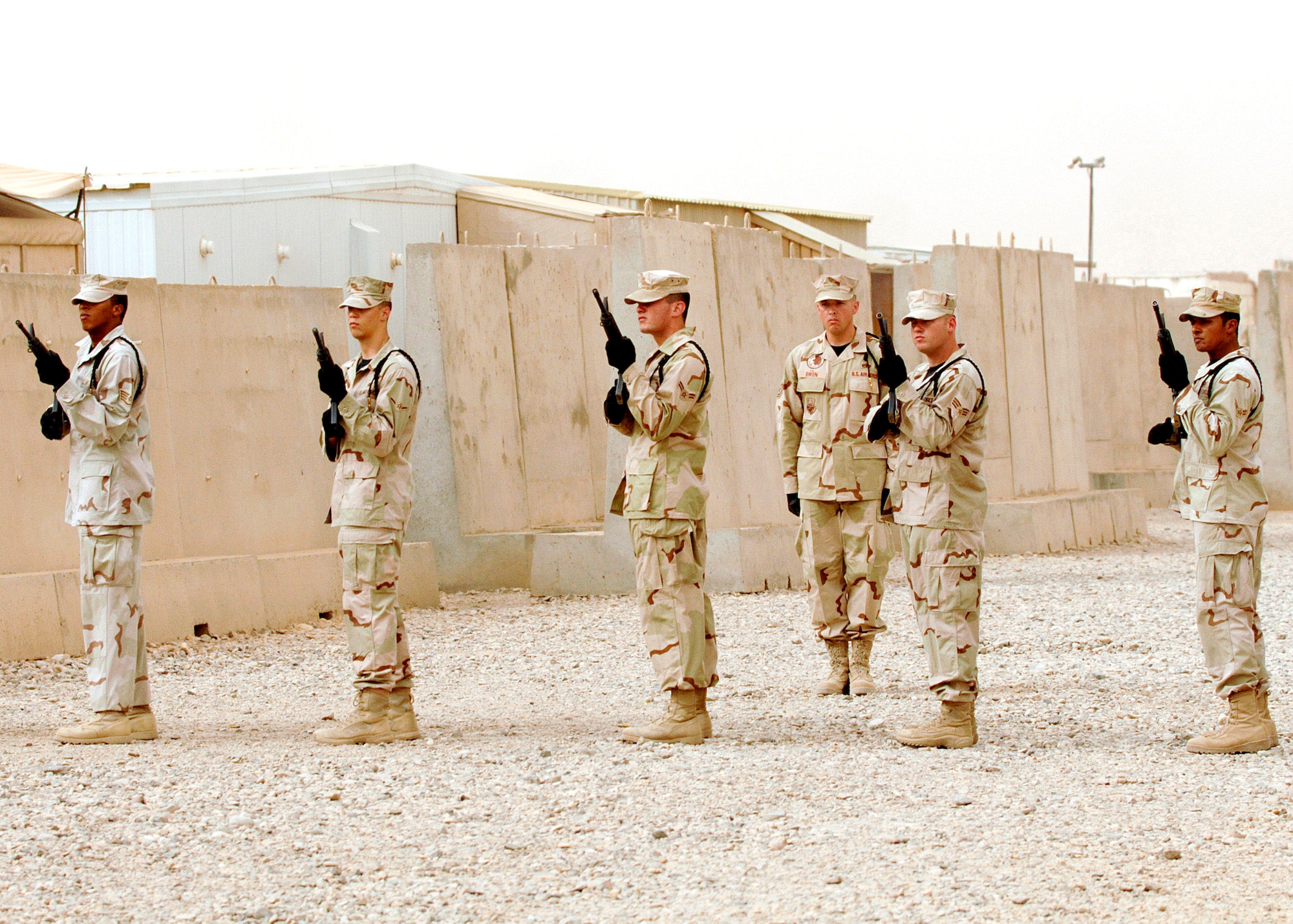 Honor guard members from the 407th Expeditionary Group at Ali Air Base, Iraq, prepare for a 21-gun salute during a fallen Airmen ceremony May 28 in remembrance of Staff Sgt. John Self at Ali Air Base. Sergeant Self, a security forces member assigned to the 732nd Expeditionary Security Forces Squadron at Camp Bucca, Iraq, was killed May 14 by an improvised explosive device while on patrol. (U.S. Air Force photo/Master Sgt. Robert W. Valenca)